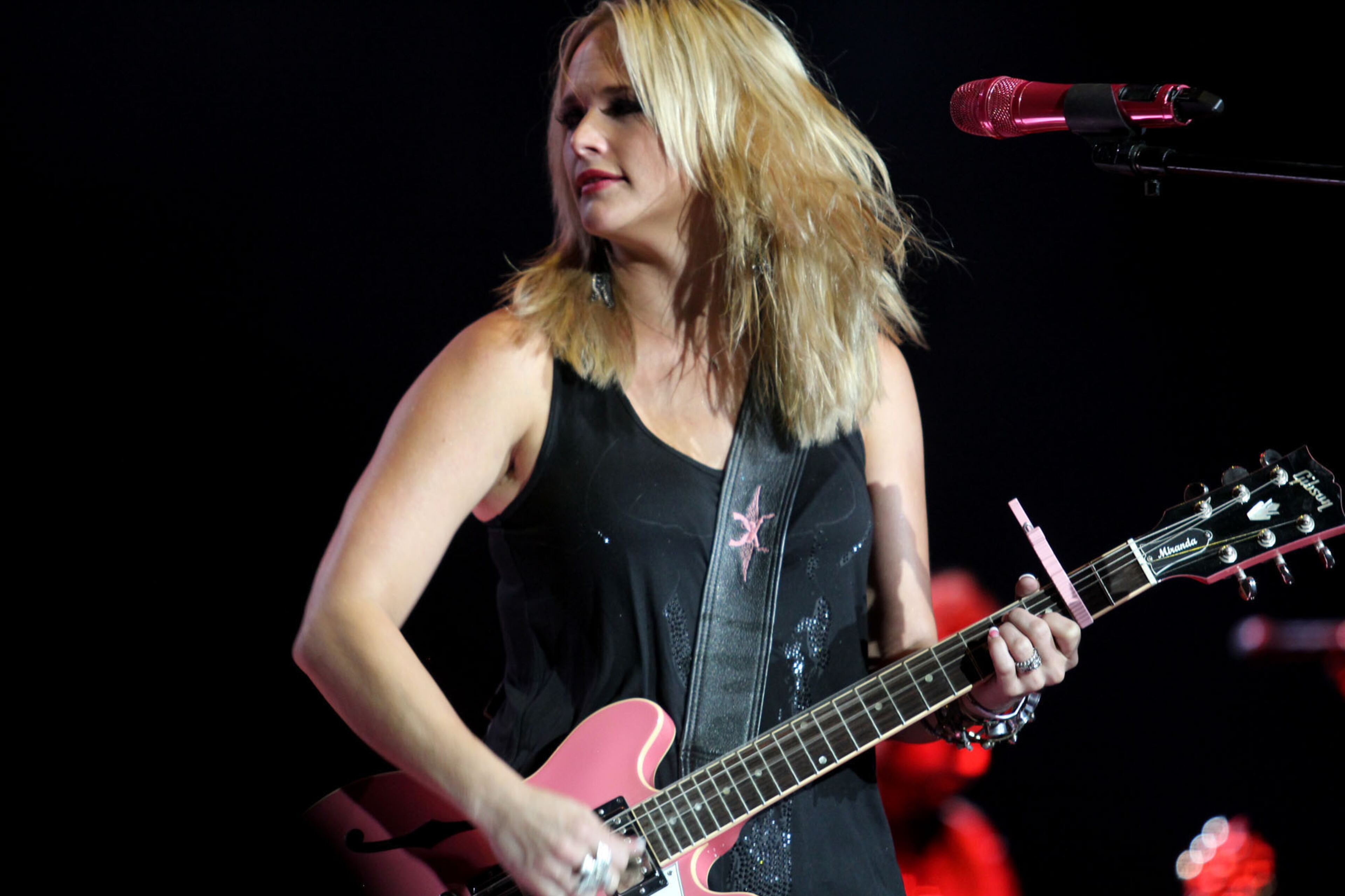 Miranda Lambert plays her pink guitar while performing her hit single "Fastest Girl In Town" from her "Four the Record" album at Aaron's Amphitheatre at Lakewood in Atlanta Thursday, Sept. 19, 2013.