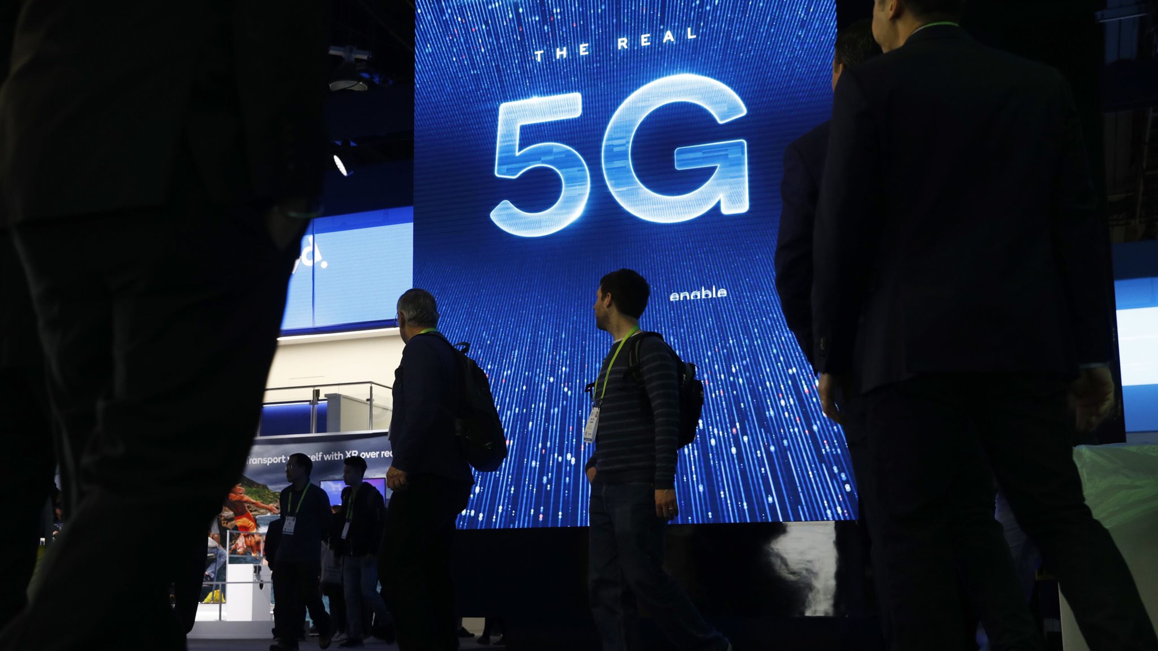 A sign advertises 5G at the Qualcomm booth at CES International in Las Vegas in 2019. 5G is a new technical standard for wireless networks that promises faster speeds; less lag, or “latency,” when connecting to the network; and the ability to connect many devices to the internet without bogging it down. (AP Photo/John Locher, File)
