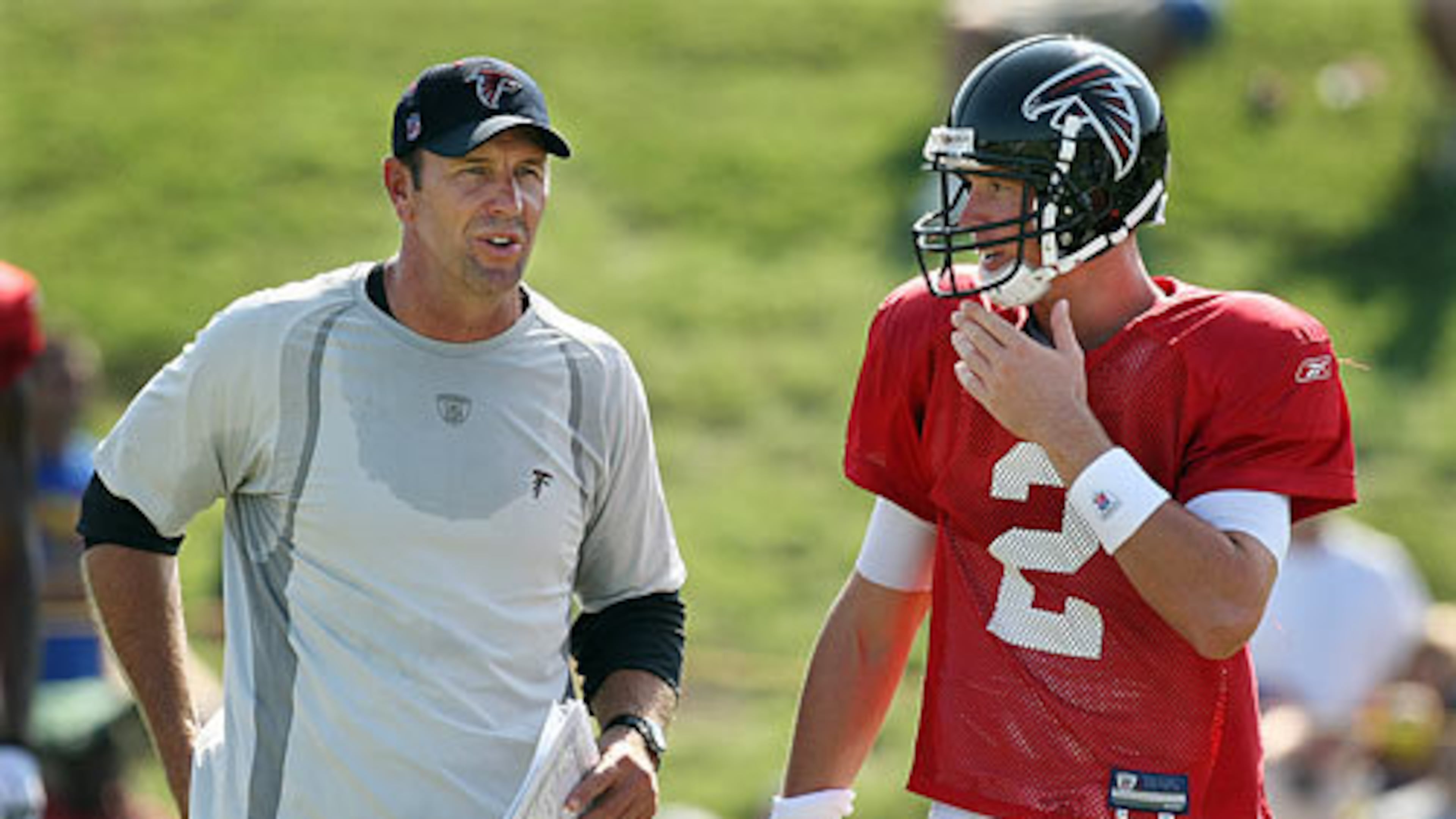 Offensive coordinator Mike Mularkey confers with quarterback Matt Ryan between plays.