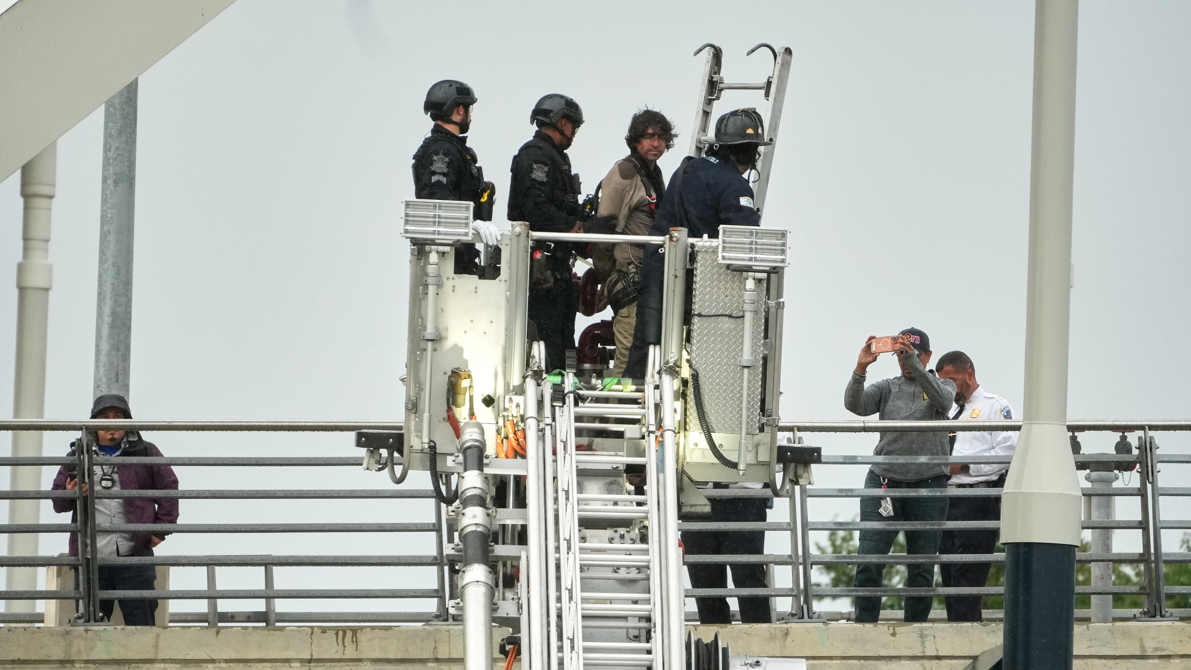 Emergency personnel remove Guido Reichstadter, 45, off the Frederick Douglass Bridge, Wednesday, May 6, 2026 in Washington. Reichstadter, who scaled to the top of the Frederick Douglass Bridge in Washington last week, has come down, after his 6-day protest. (AP Photo/Julia Demaree-Nikhinson)