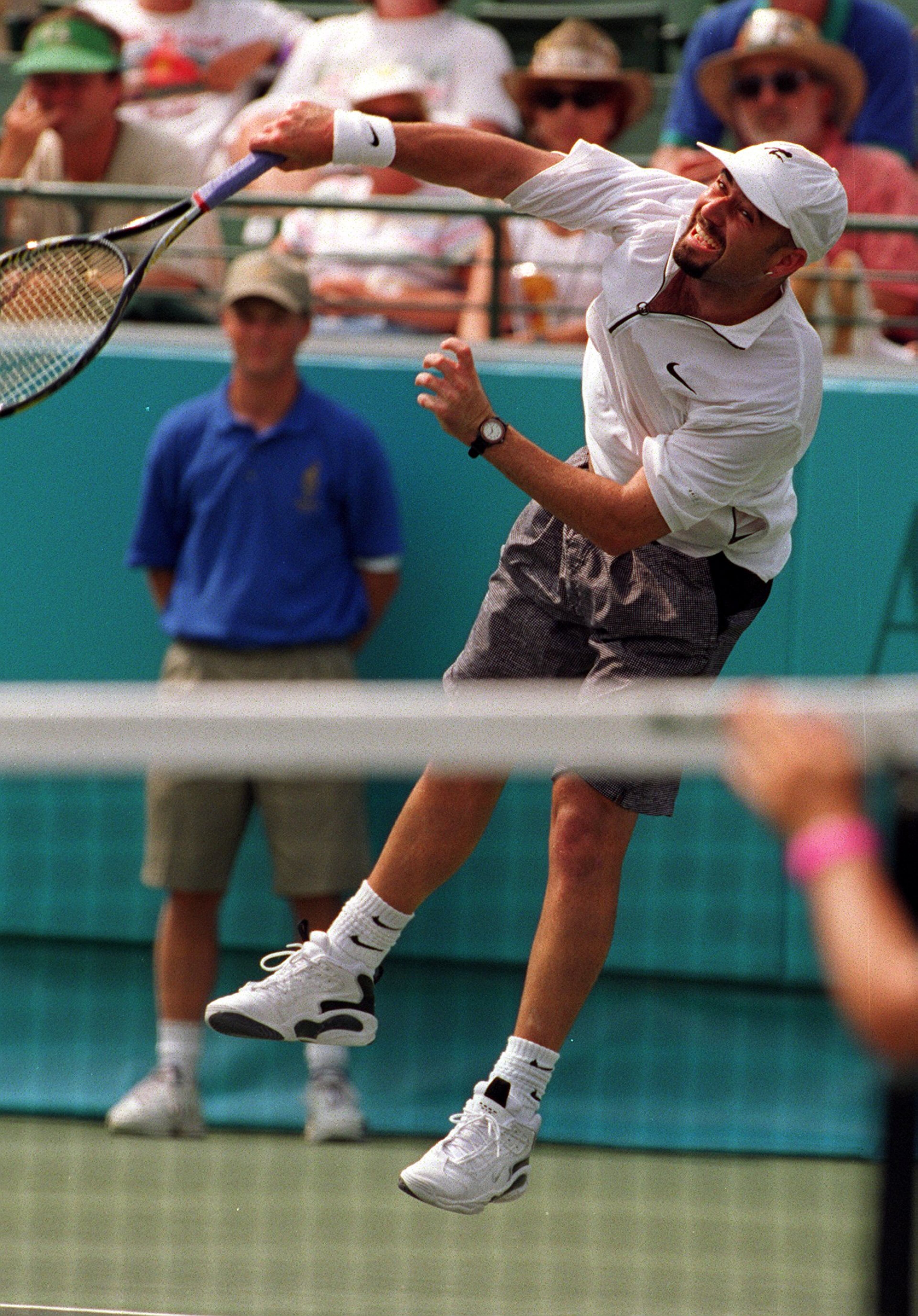 Andre Agassi crushes a serve on his way to a gold medal in the men's tennis finals at the Stone Mountain Tennis Center. (AJC Staff Photo/Frank Niemeir)