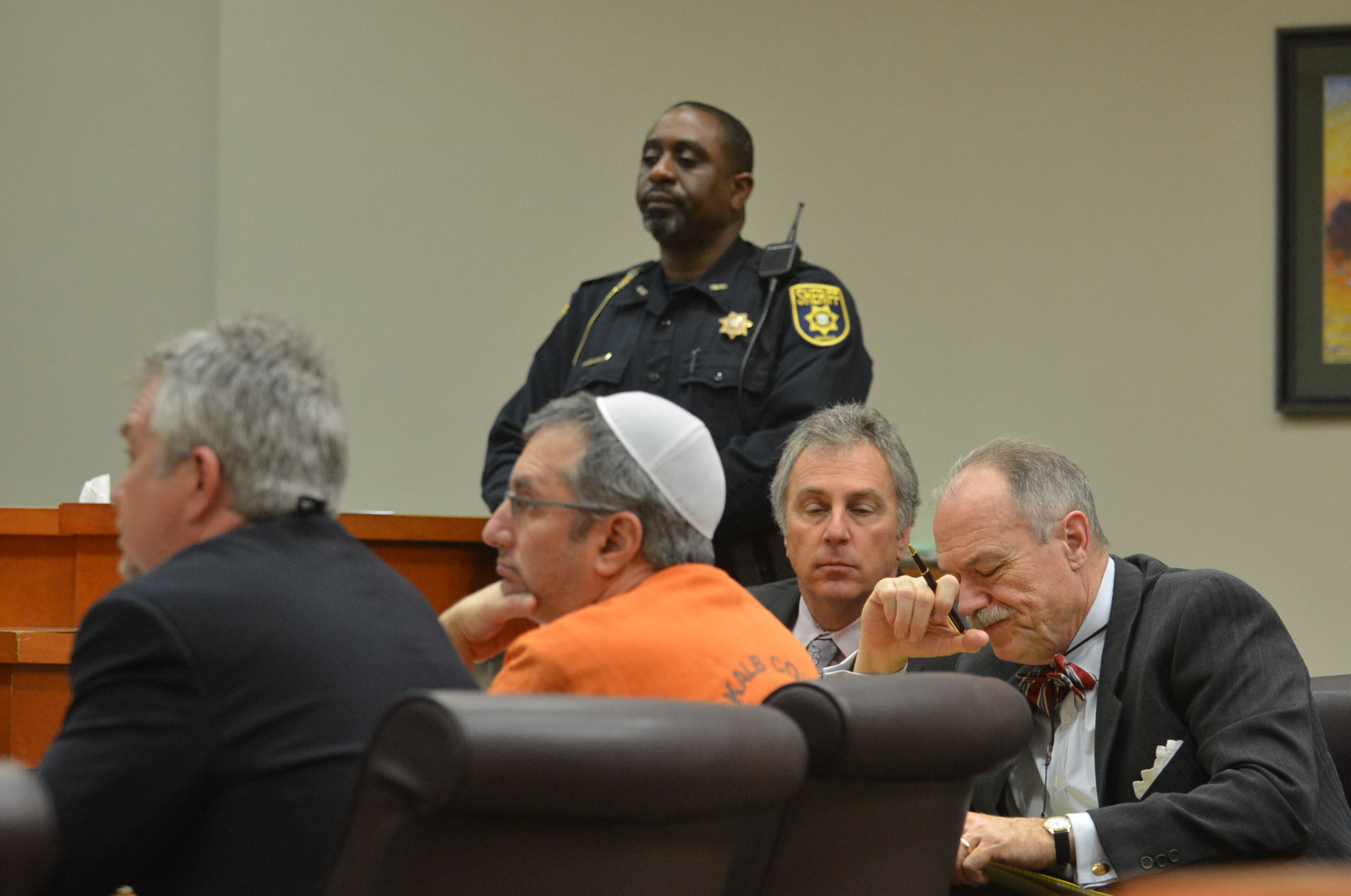 Hemy Neuman entered court shortly before 1:30 p.m. Tuesday, wearing an orange DeKalb County jumpsuit. He sat at the defense table with his attorneys, Doug Peters and Bob Rubin. DeKalb Superior Court Judge Gregory A. Adams presided.