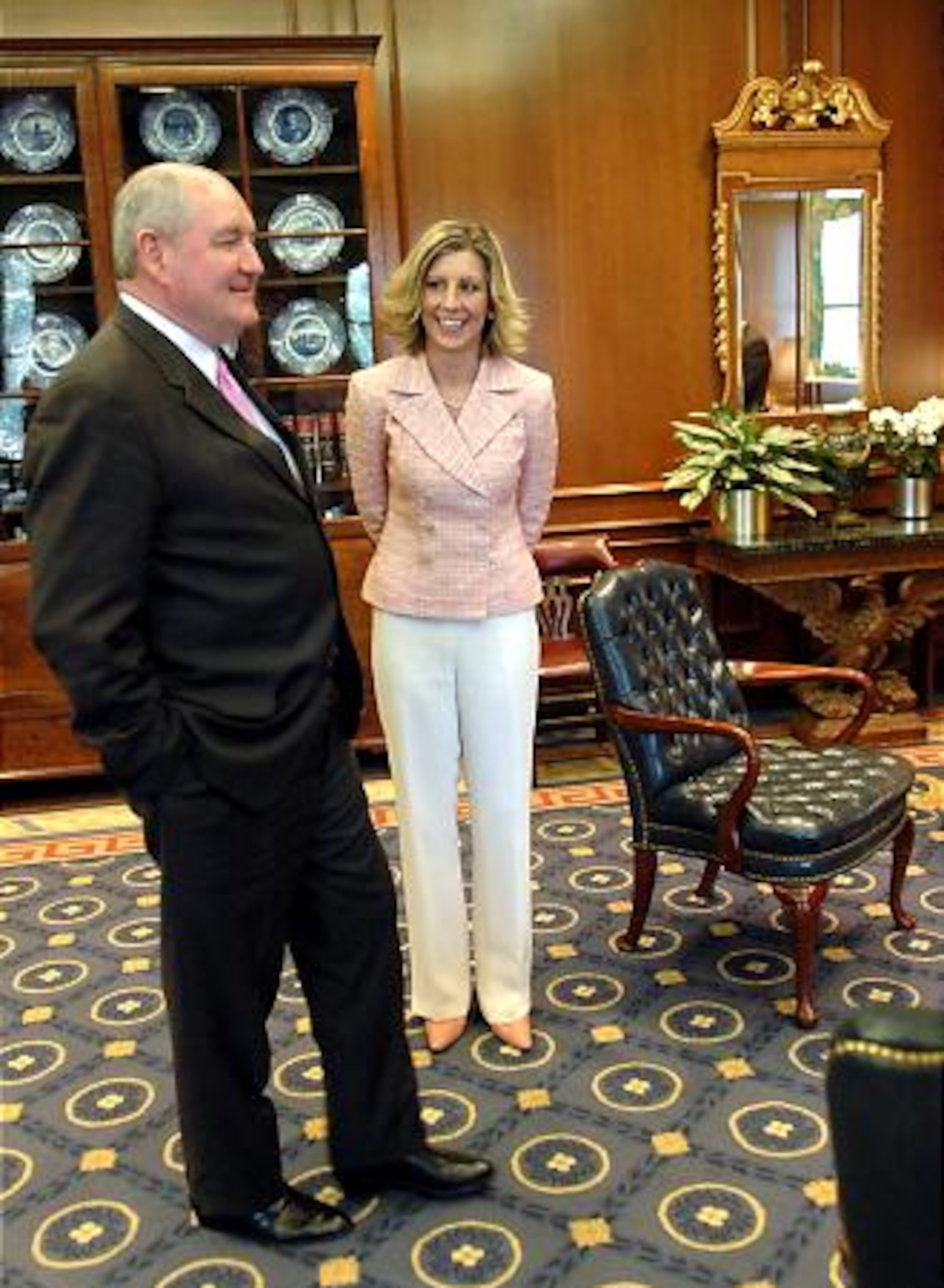 Her reward, given to her by Gov. Sonny Perdue (left), more than $70,000.