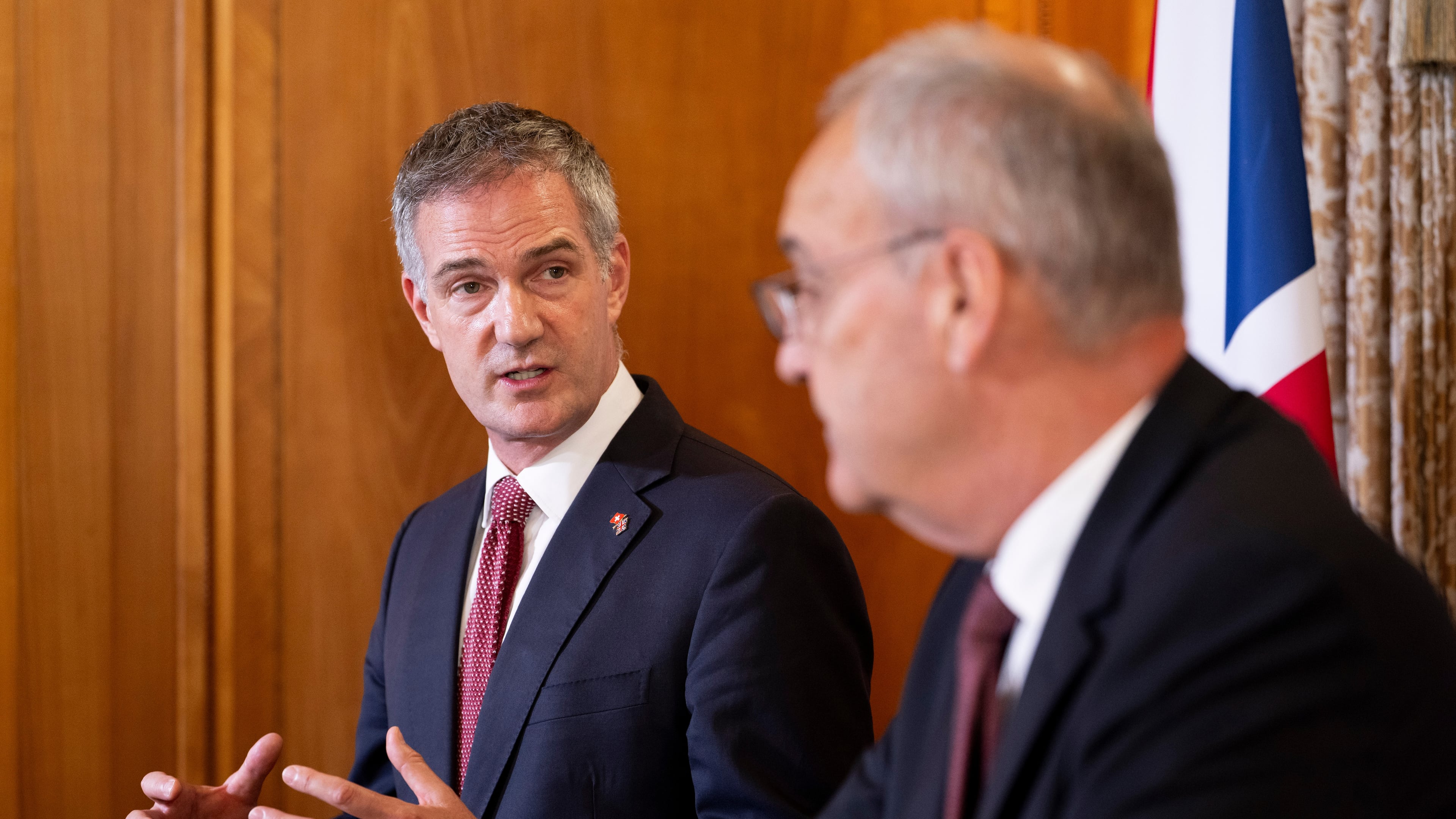 Britain's Secretary of State for Business and Trade, Peter Kyle, left, and Swiss Federal President Guy Parmelin talk prior to a press briefing, held as part of a bilateral meeting, at the Hotel Bellevue Palace in Bern, Switzerland, Monday, July 13, 2026. Parmelin and Kyle announced the conclusion of negotiations on a modernised free trade agreement between Switzerland and the United Kingdom. (Anthony Anex/Keystone via AP)