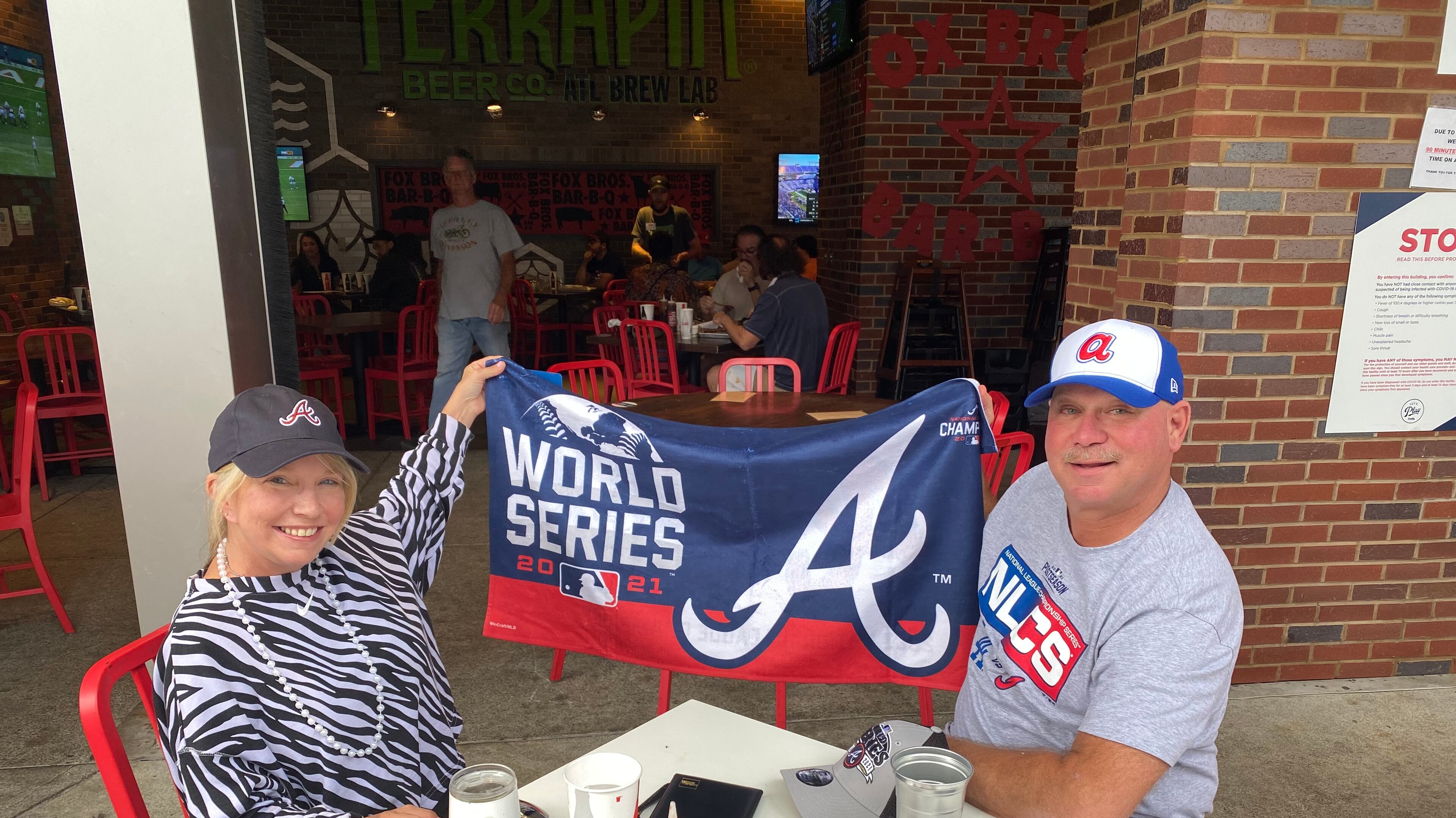 Hollie and Darrell Giannotti, of Cumming, bought Atlanta Braves gear from the team's Clubhouse Store on Sunday. Photo: Adrianne Murchison