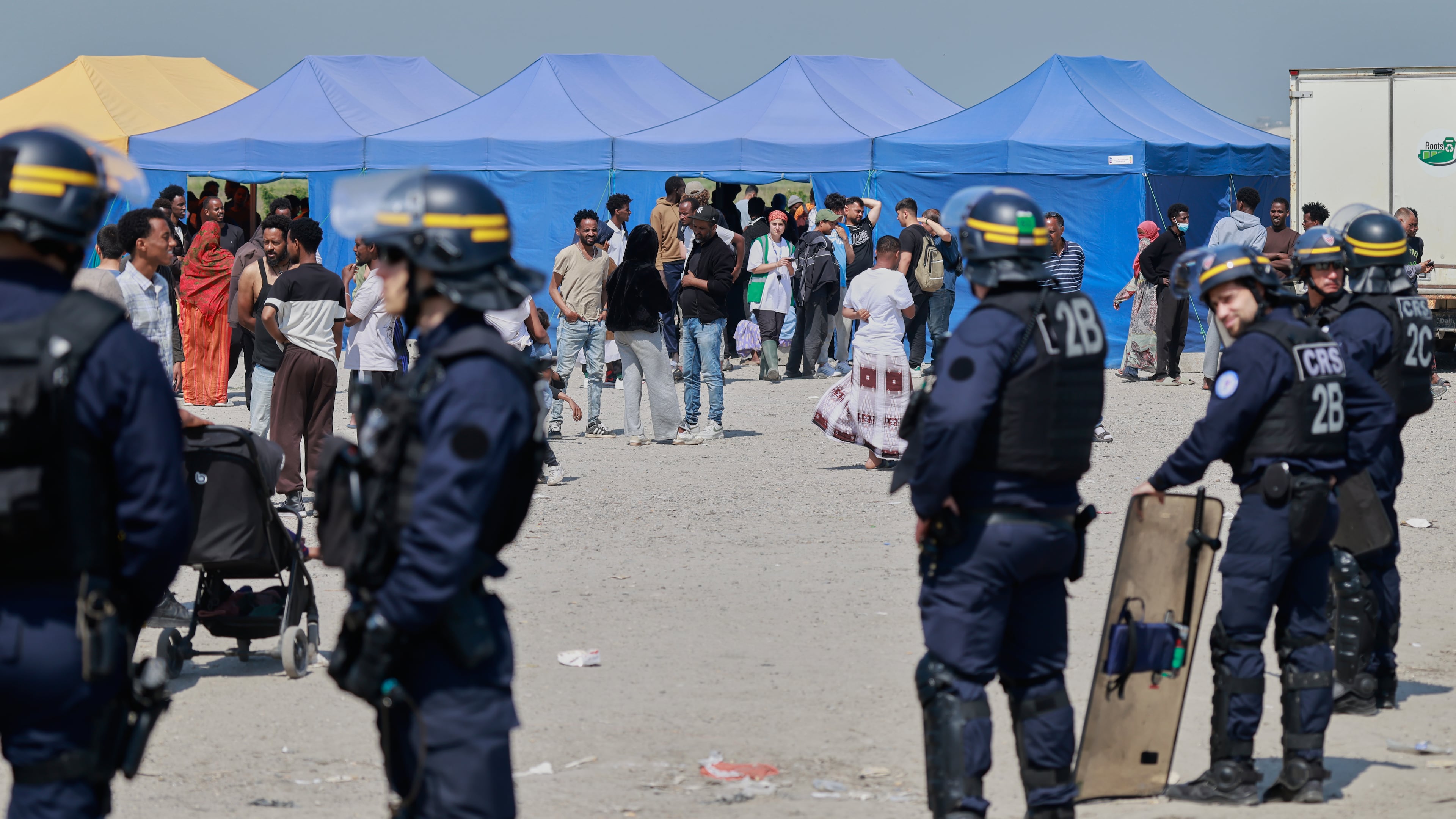 Police conduct a search operation at a makeshift camp of migrants who want to cross the English Channel to Britain near Dunkirk, northern France, Wednesday, May 27, 2026. (AP Photo/Jean-Francois Badias)
