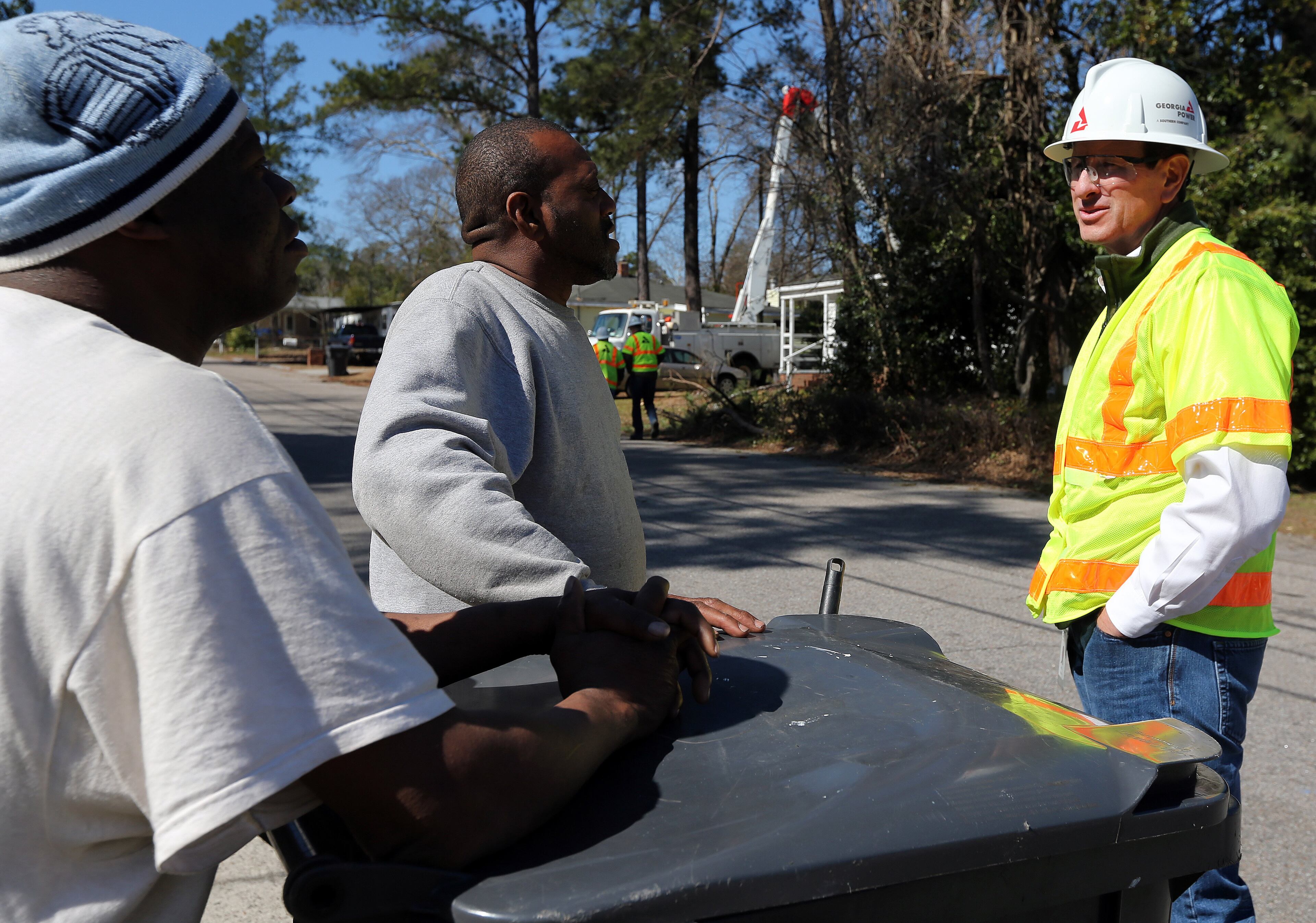Georgia Power President and CEO Paul Bowers talks with South Augusta residents Frank Scott, left, and Nathan Smith during his visit to the storm-damaged area Saturday afternoon February 15, 2014. BEN GRAY / BGRAY@AJC.COM