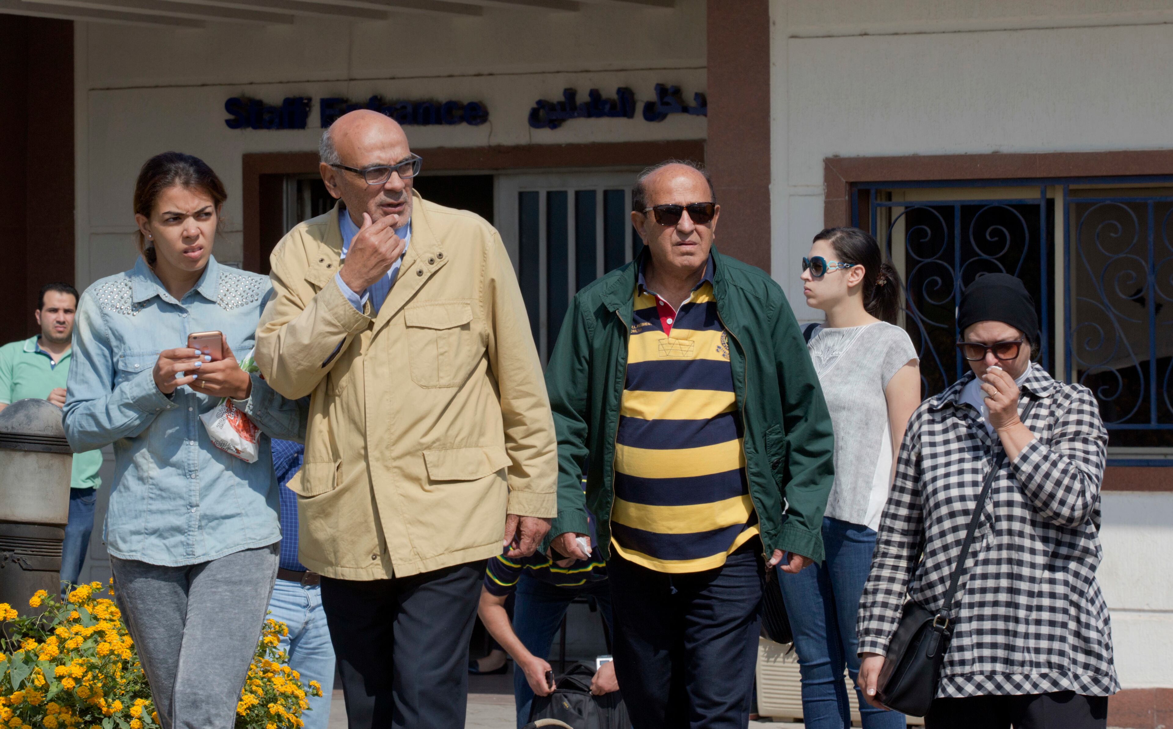 Relatives of passengers on a vanished EgyptAir flight leave the Egyptair in-flight service building where they were held at Cairo International Airport, Egypt, Thursday, May 19, 2016. Egyptian aviation officials say an EgyptAir flight from Paris to Cairo with 66 passengers and crew on board has crashed. The officials say the search is now underway for the debris. (AP Photo/Amr Nabil)