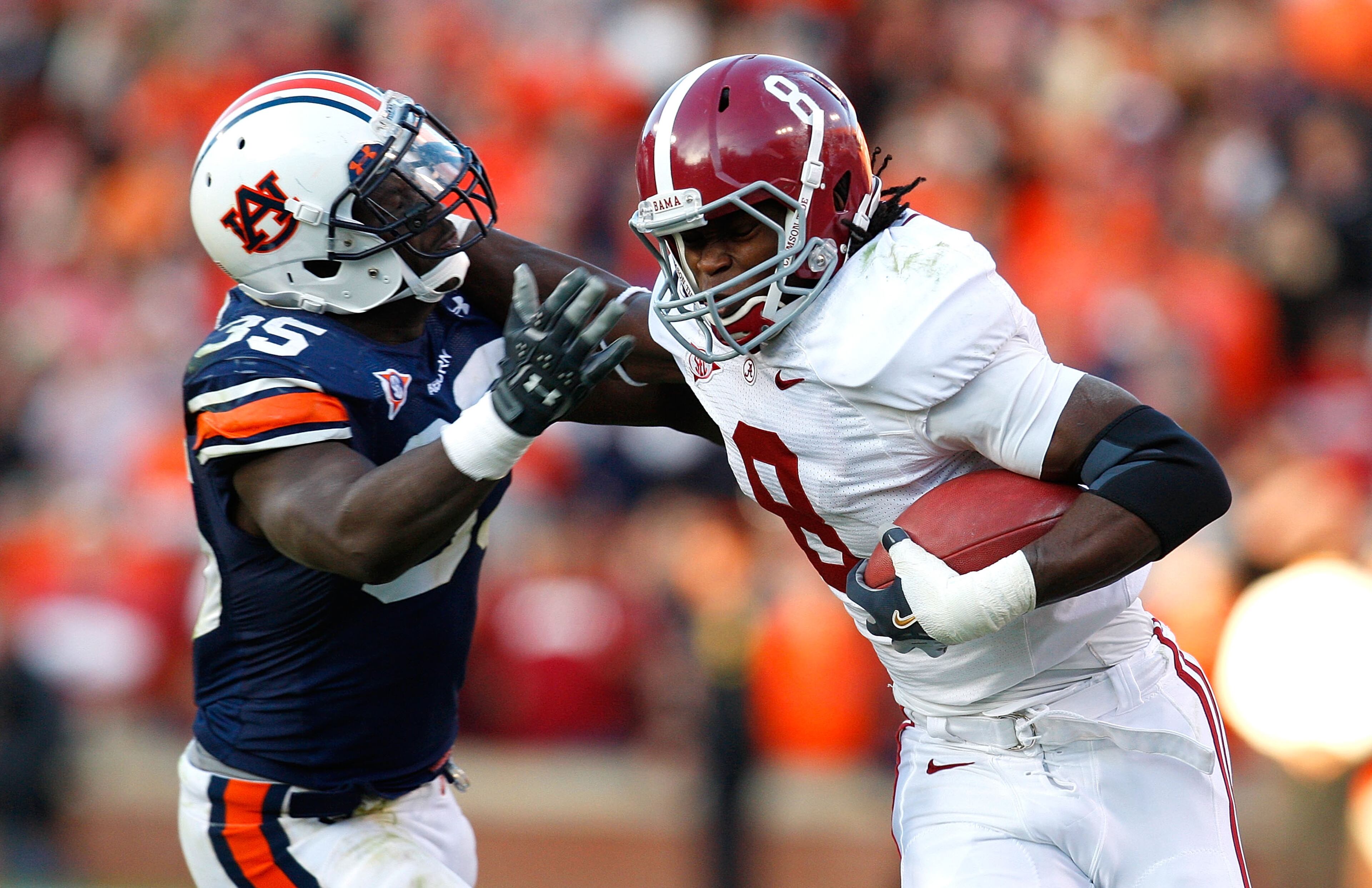 AUBURN, AL - NOVEMBER 27: Julio Jones #8 of the Alabama Crimson Tide tries to break a tackle by Jonathan Evans #35 of the Auburn Tigers at Jordan-Hare Stadium on November 27, 2009 in Auburn, Alabama. (Photo by Kevin C. Cox/Getty Images)