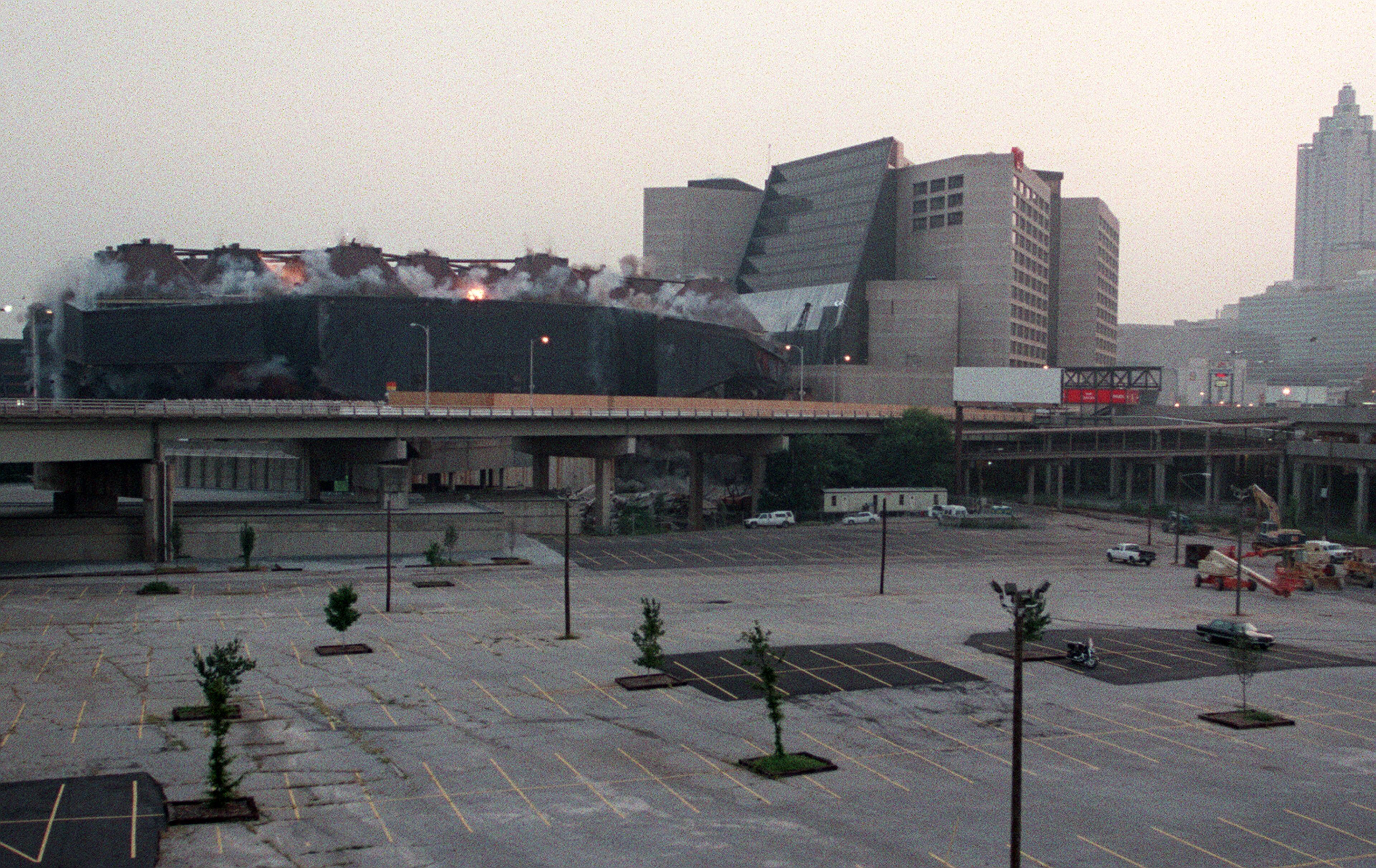 970726 - Atlanta, Georgia - Orange explosive charges can be seen inside the Omni arena as it is imploded early Saturday morning, July 26, in downtown Atlanta. (AJC Staff Photo/Celine Bufkin)