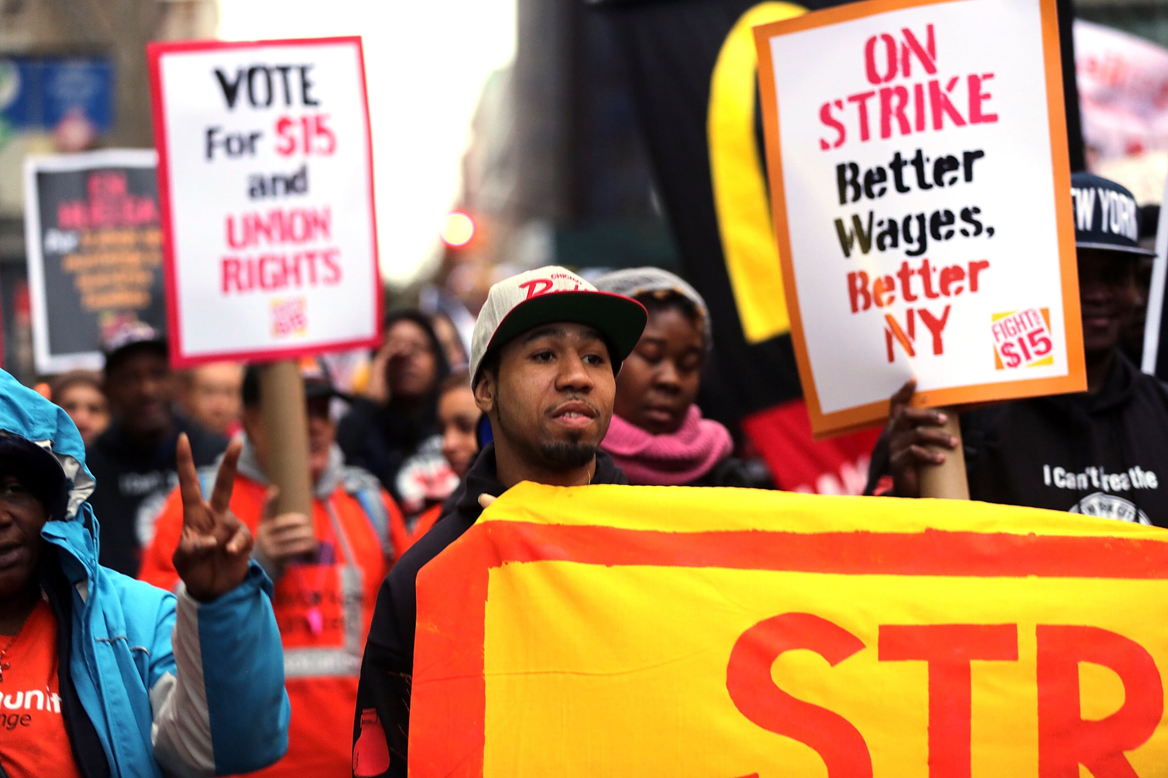 NEW YORK, NY - NOVEMBER 10: Low wage workers and supporters protest for a $15 an hour minimum wage on November 10, 2015 in New York, United States. In what organizers are calling a National Day of Action for $15 and hour minimum wage, thousands of people took to the streets across the country to stage protests in front of businesses that are paying some of their workers the minimum wage. Home care workers, employees in retail and fast food restaurants say that the current minimum is not a living wage. (Photo by Spencer Platt/Getty Images)