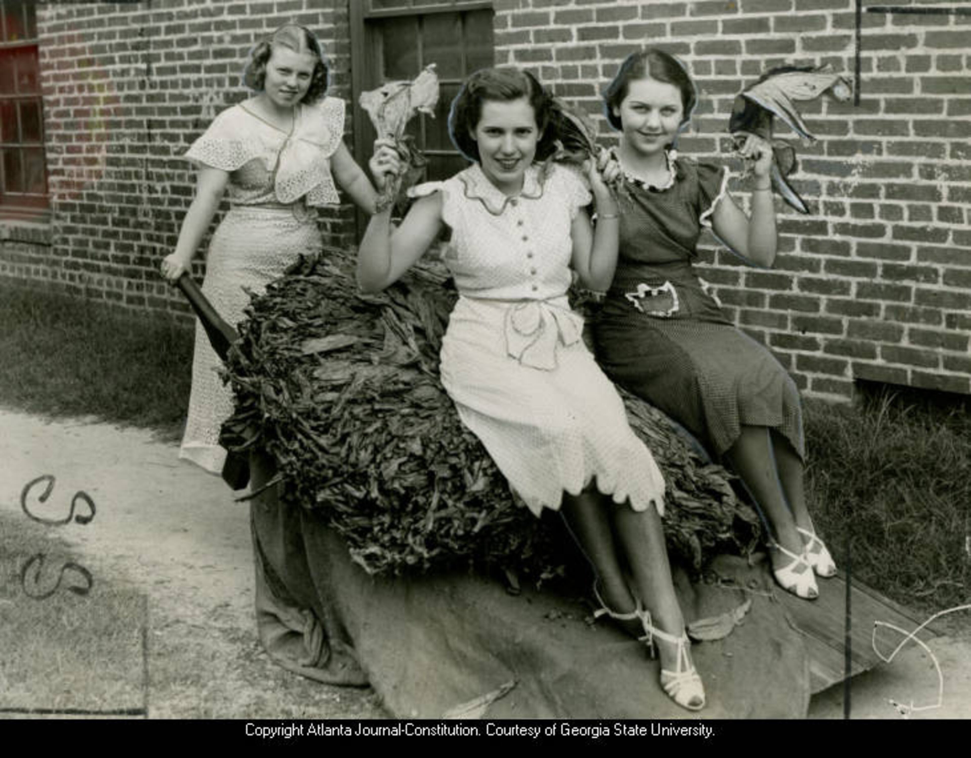 Martha Louise Johnson, Maranelle Hatcher, and Marion Majors pose with a wheelbarrow of tobacco, Moultrie, Georgia, July 1946.