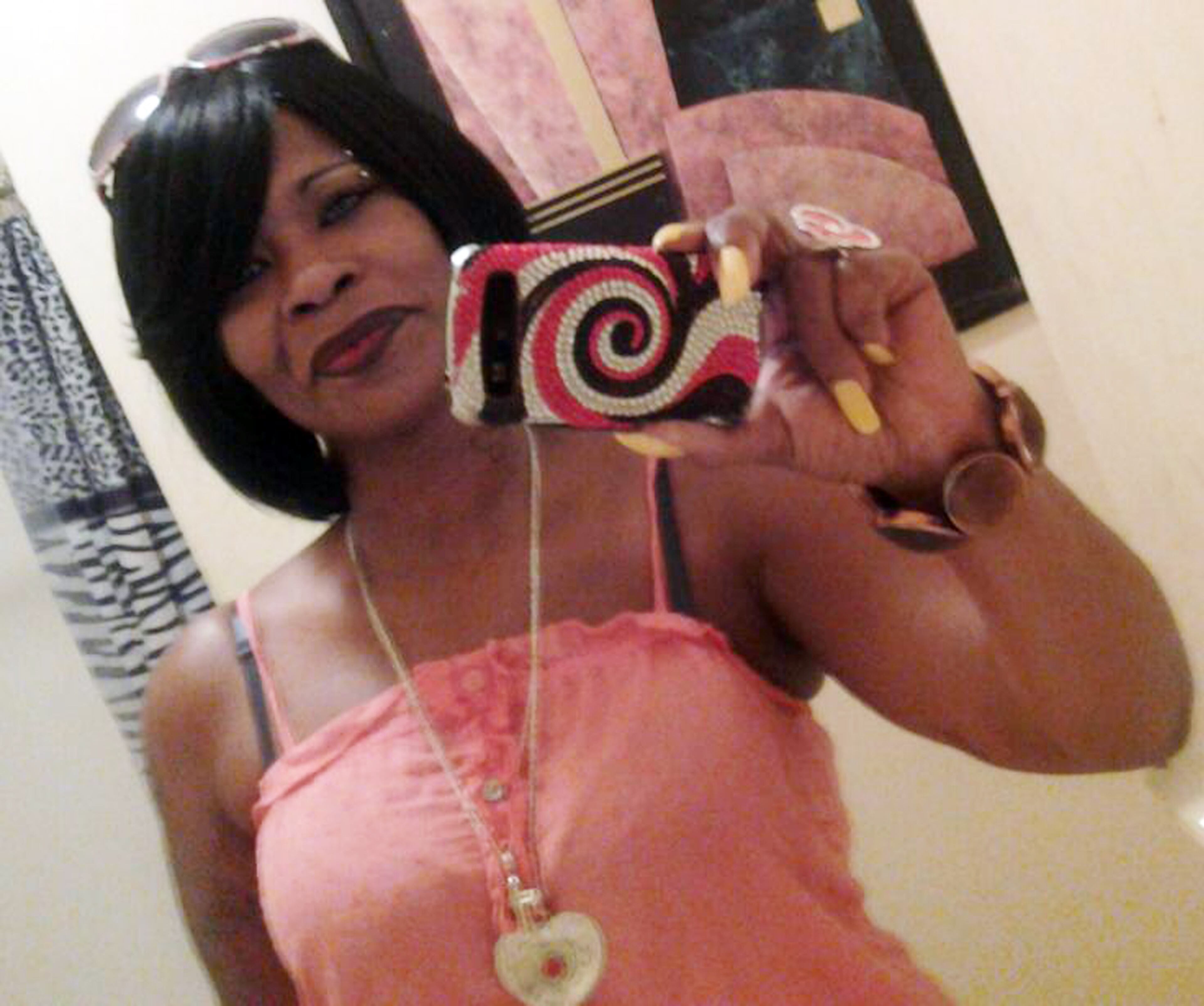 Donna's daughters loved to dress their mother in wigs, false eye lashes, makeup and long finger nails. Here, she takes a selfie of herself all dolled up.