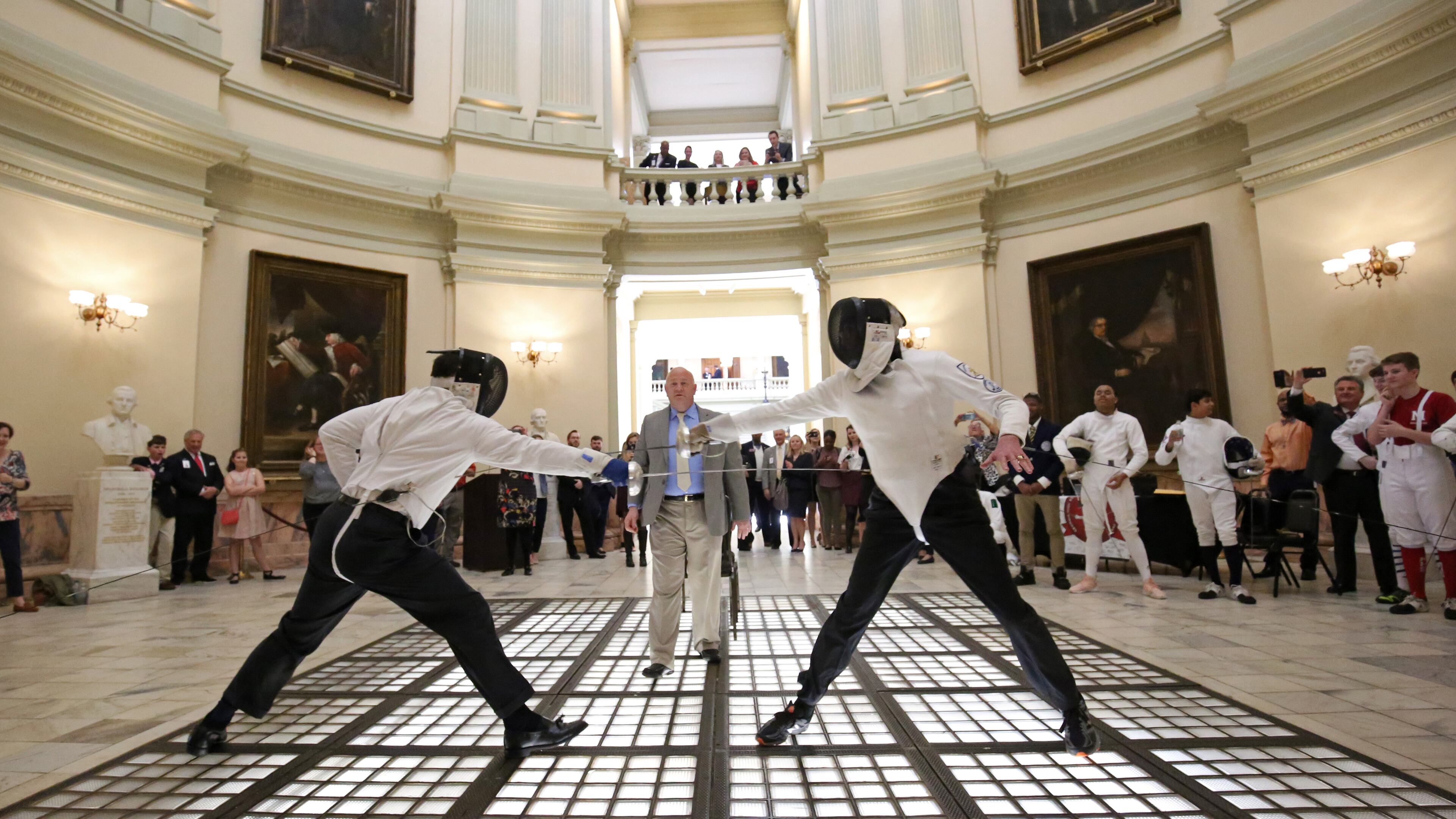 February 22, 2018 - Atlanta, Ga: Senator William T. Ligon, R - Brunswick, left, and Rep. Tom Taylor, R - Dunwoody, right, fence against each other during the Dual Under the Dome by the Georgia High School Fencing League in the Capitol Rotunda during Legislative day 25 at the Georgia State Capitol Thursday, February 22, 2018, in Atlanta. PHOTO / JASON GETZ