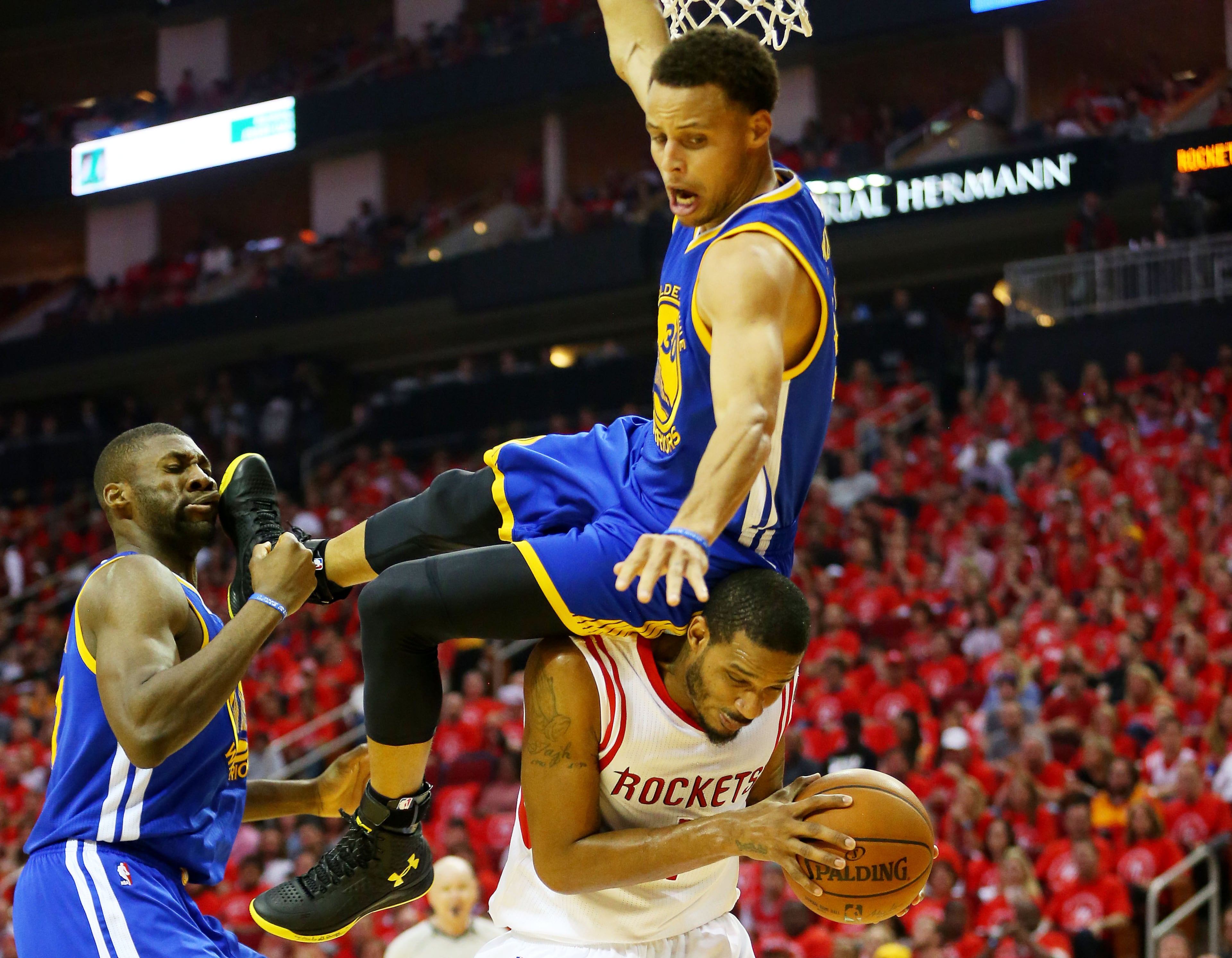 HOUSTON, TX - MAY 25: Stephen Curry #30 of the Golden State Warriors falls over Trevor Ariza #1 of the Houston Rockets on his way to an injury in the second quarter during Game Four of the Western Conference Finals of the 2015 NBA Playoffs at Toyota Center on May 25, 2015 in Houston, Texas. NOTE TO USER: User expressly acknowledges and agrees that, by downloading and or using this photograph, user is consenting to the terms and conditions of Getty Images License Agreement. (Photo by Ronald Martinez/Getty Images)