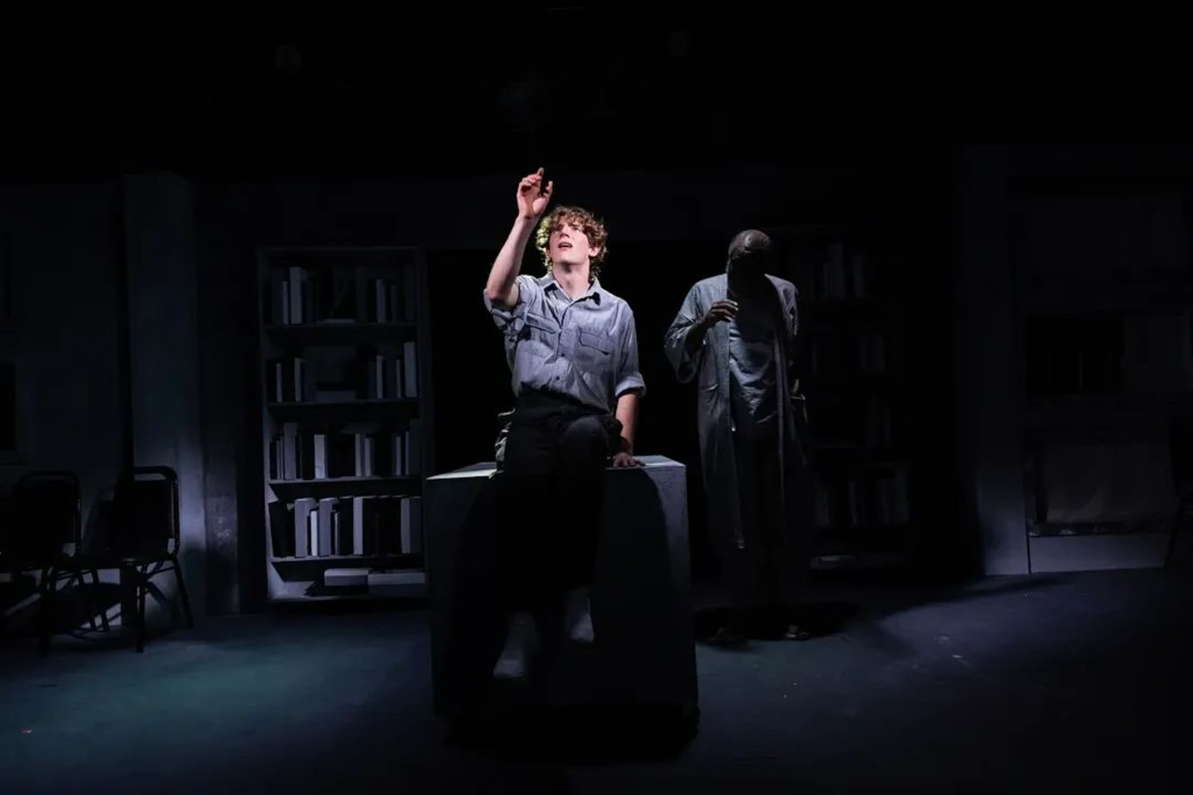 Aavyn Lee (foreground) and Rob Cleveland perform in Georgia Ensemble Theatre's 2026 remounting of "The Giver." (Casey Gardner Ford)