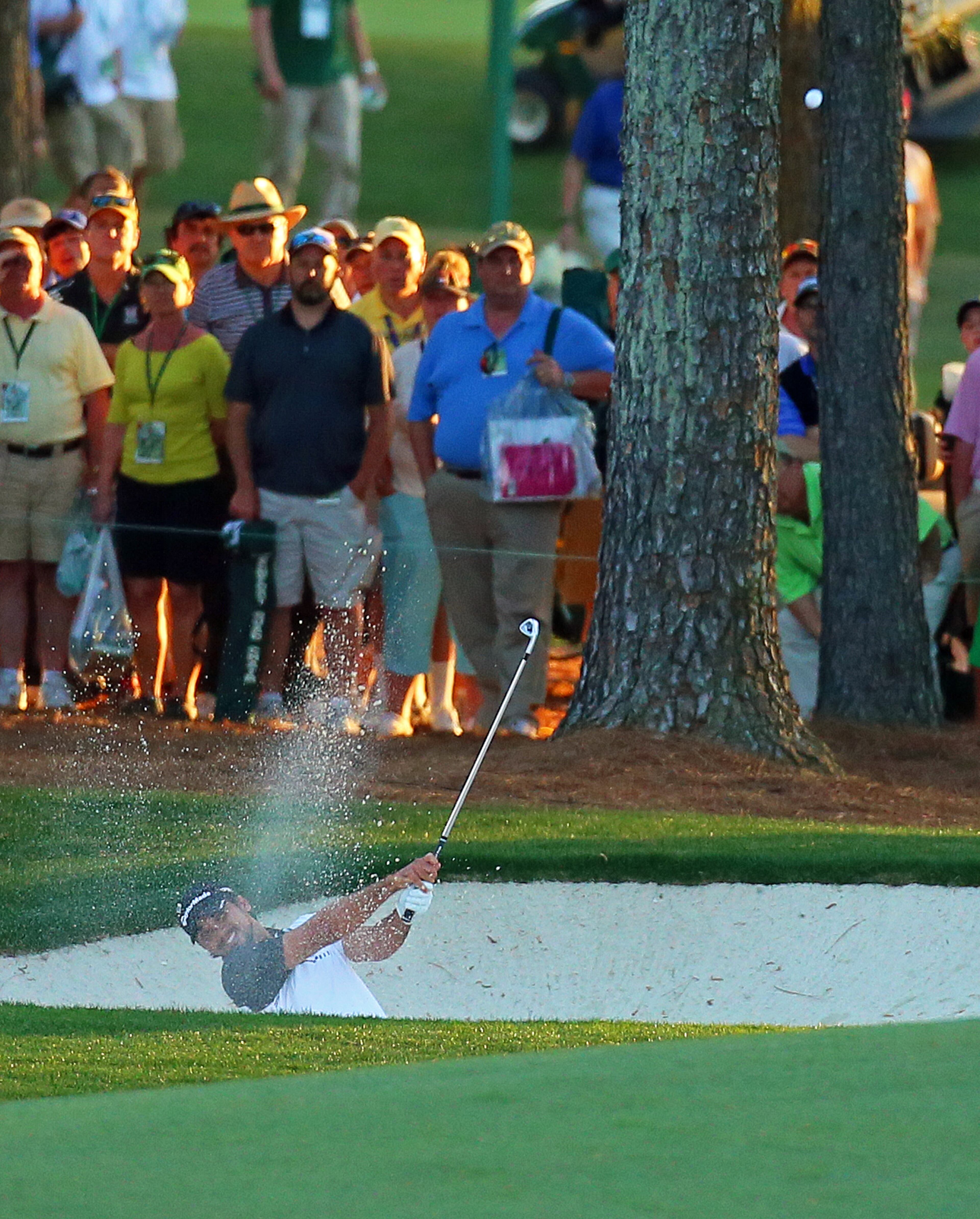 Jason Day hits from the fairway bunker to the 18th green on his way to a par to finish at 6-under for the lead in the Masters on Friday, April 12, 2013, in Augusta. CURTIS COMPTON/ CCOMPTON@AJC.COM