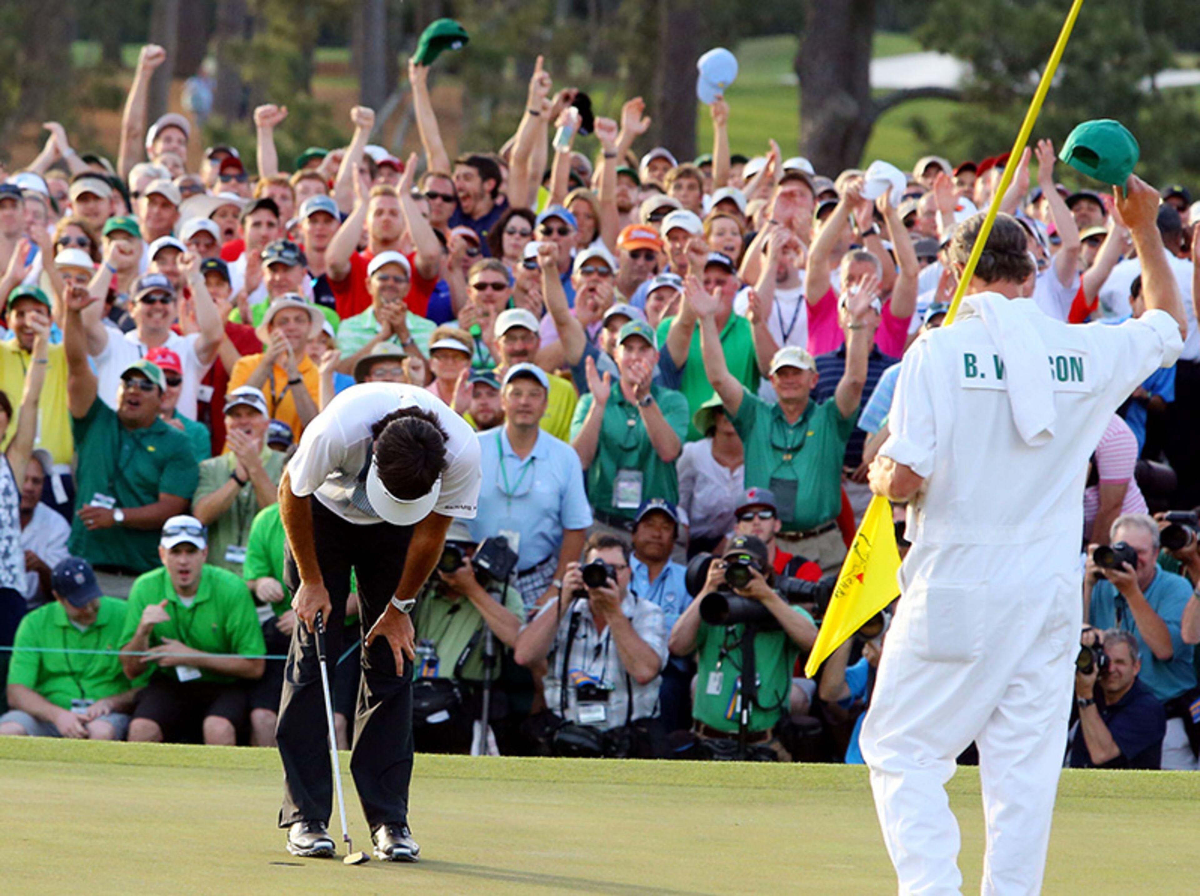 After sinking his putt on 18th, Bubba Watson bends over to soak in winning his second Masters Tournament Sunday, April 13, 2014, at Augusta National Golf Club.
