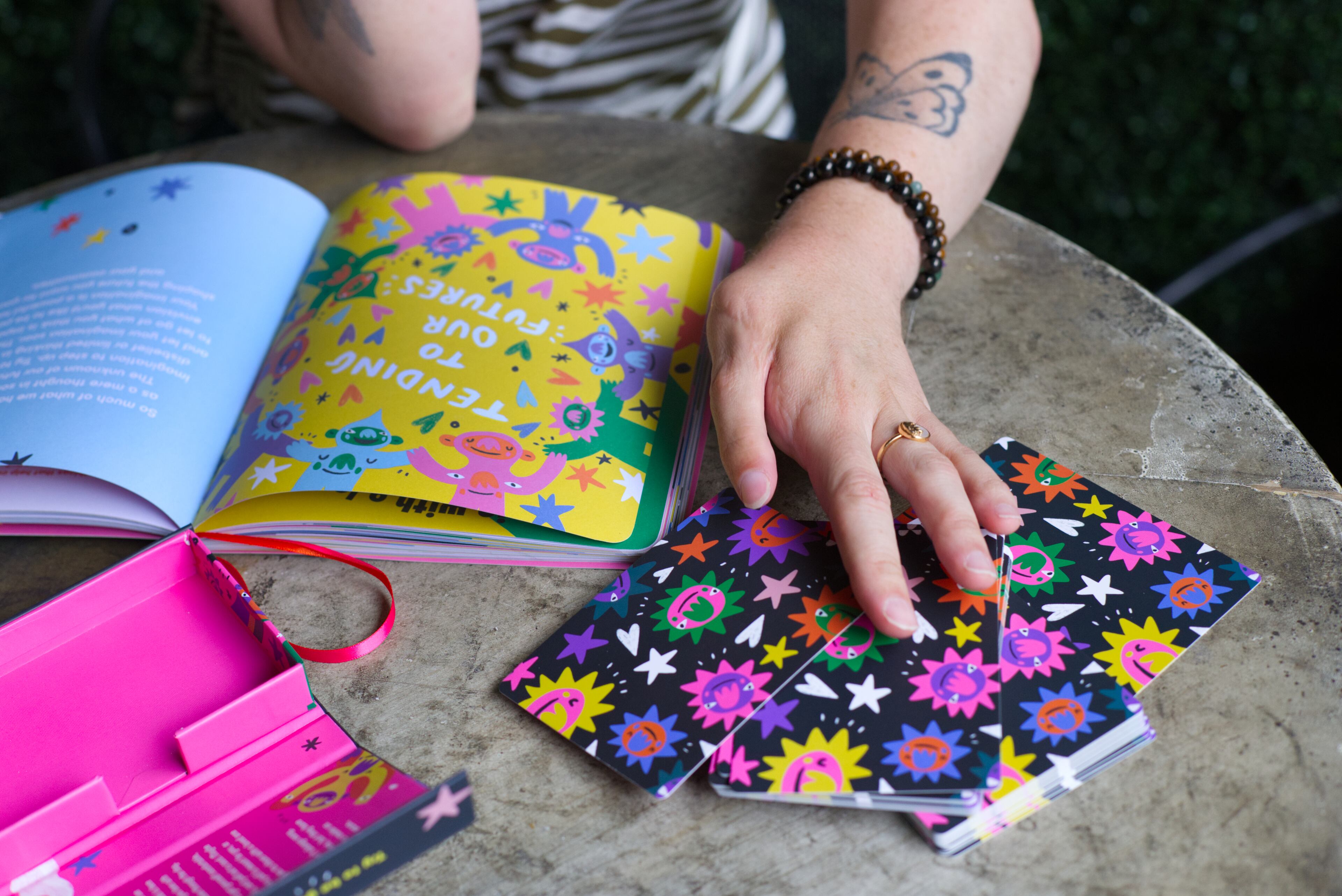 Barry Lee shows the new "Gentle Reminders Journal" (left) and the previously published oracle card deck (right). Lee was born with Nager syndrome, a rare genetic condition that affects the development of a child’s face, arms and hands. (Courtesy of Dustin Timbrook)