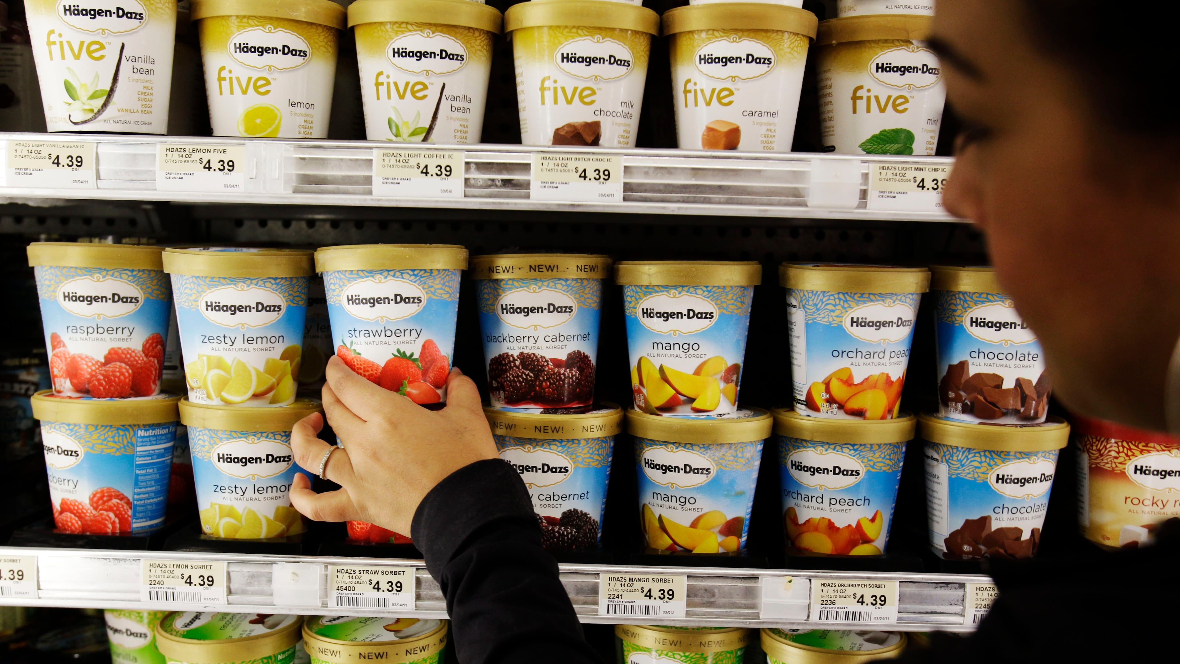 FILE -A shopper picks out General Mill's Haagen-Dazs ice cream at Piazza's grocery store in Palo Alto, Calif., June 28, 2011. (AP Photo/Paul Sakuma, File)