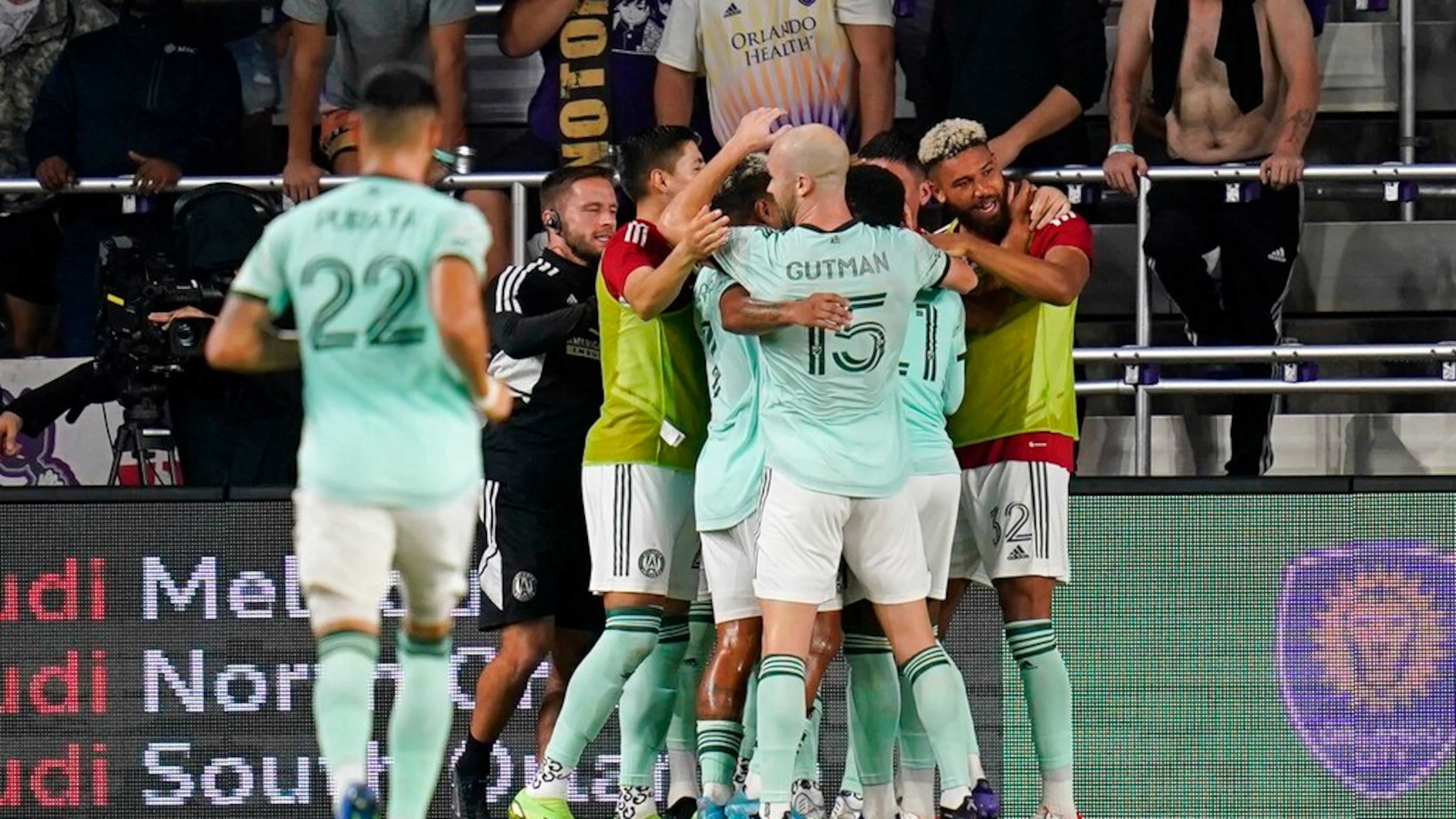 Atlanta United players celebrate as they surround midfielder Thiago Almada after he scored a goal against Orlando City during the second half of an MLS soccer match Wednesday, Sept. 14, 2022, in Orlando, Fla. (AP Photo/John Raoux)