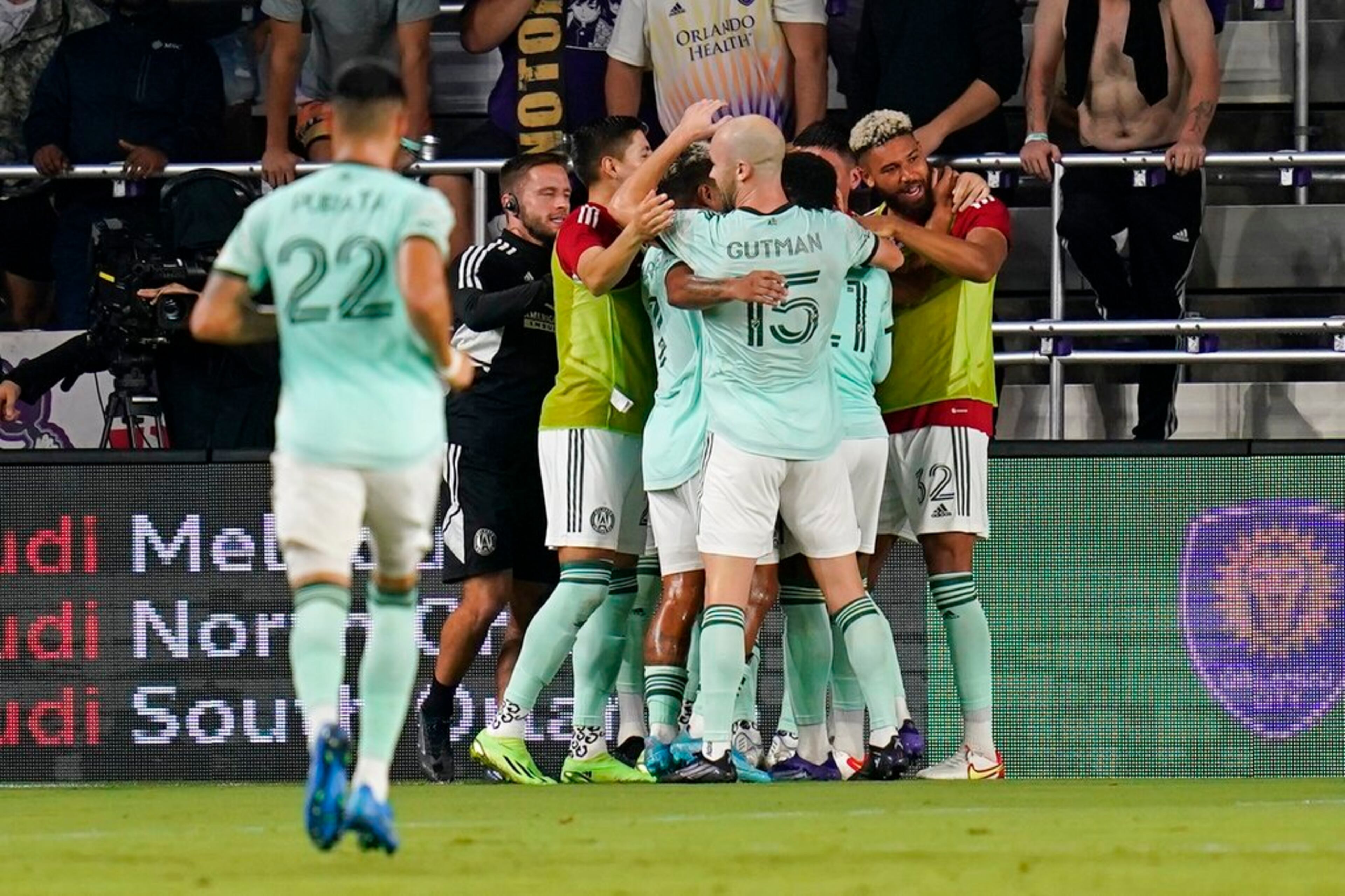 Atlanta United players celebrate as they surround midfielder Thiago Almada after he scored a goal against Orlando City during the second half of an MLS soccer match Wednesday, Sept. 14, 2022, in Orlando, Fla. Atlanta United won 1-0. (AP Photo/John Raoux)