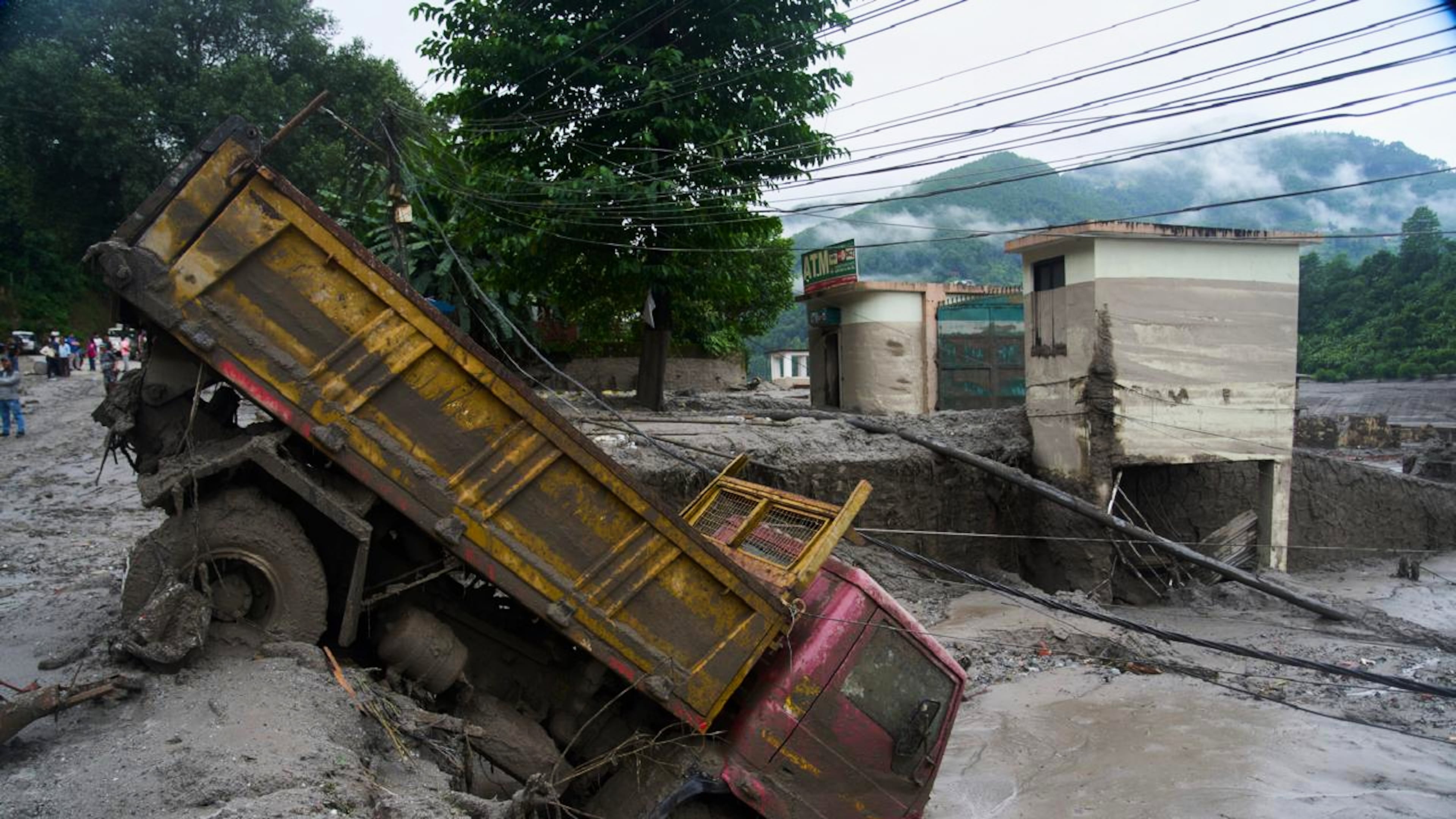 A vehicle is seen in the aftermath of a flash floods in Devighat in the Nuwakot district in Nepal. Thursday, Aug 27, 2026. (AP Photo/Niranjan Shrestha)