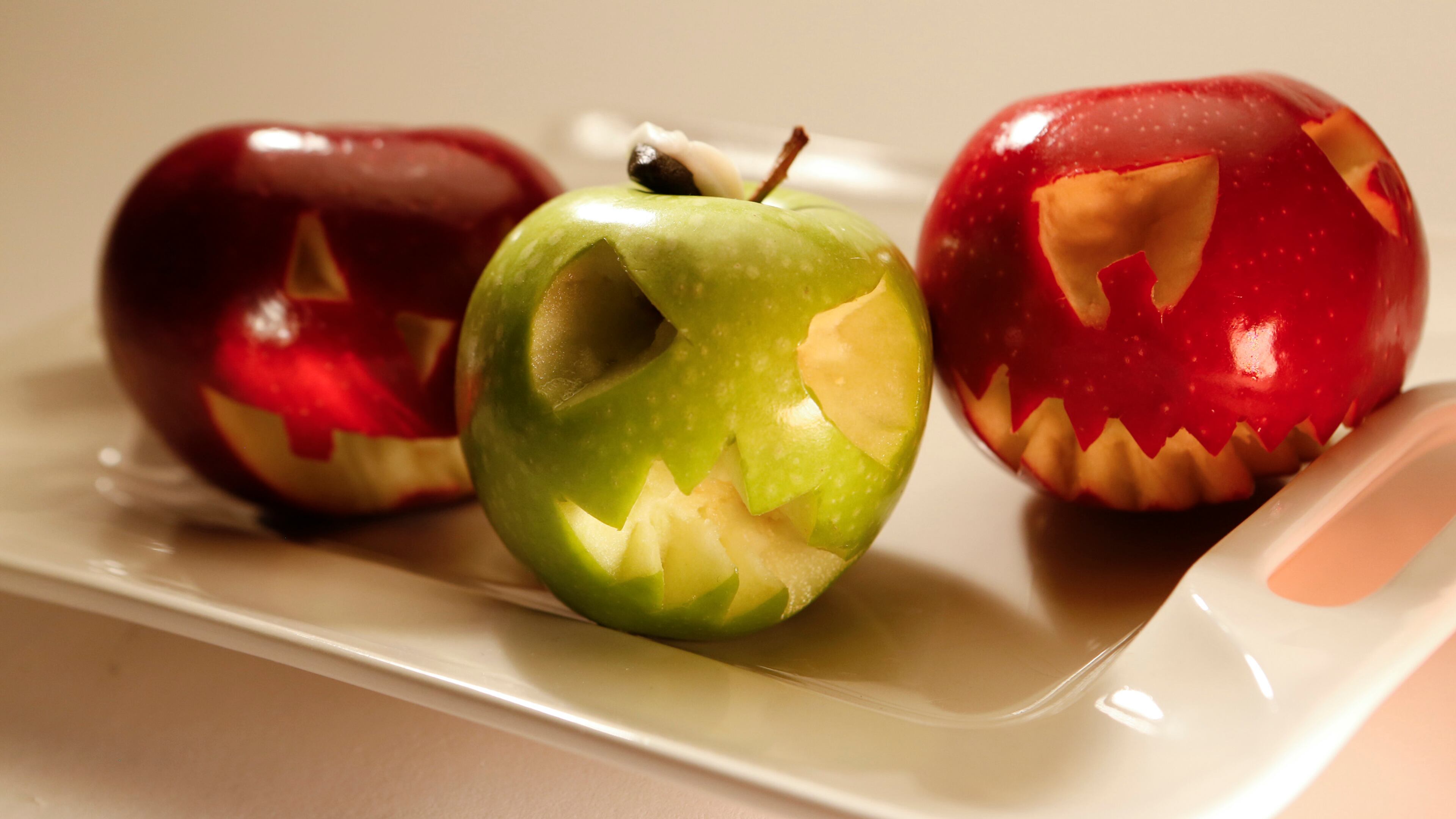 Carve simple jack-o'-lantern faces into apples, oranges and more before packing the fruit in lunch bags or serving as snacks. If you're carving ahead of time, dab the carved areas with a little lemon juice to prevent the fruit from browning. (Anne Cusack/Los Angeles Times/MCT)