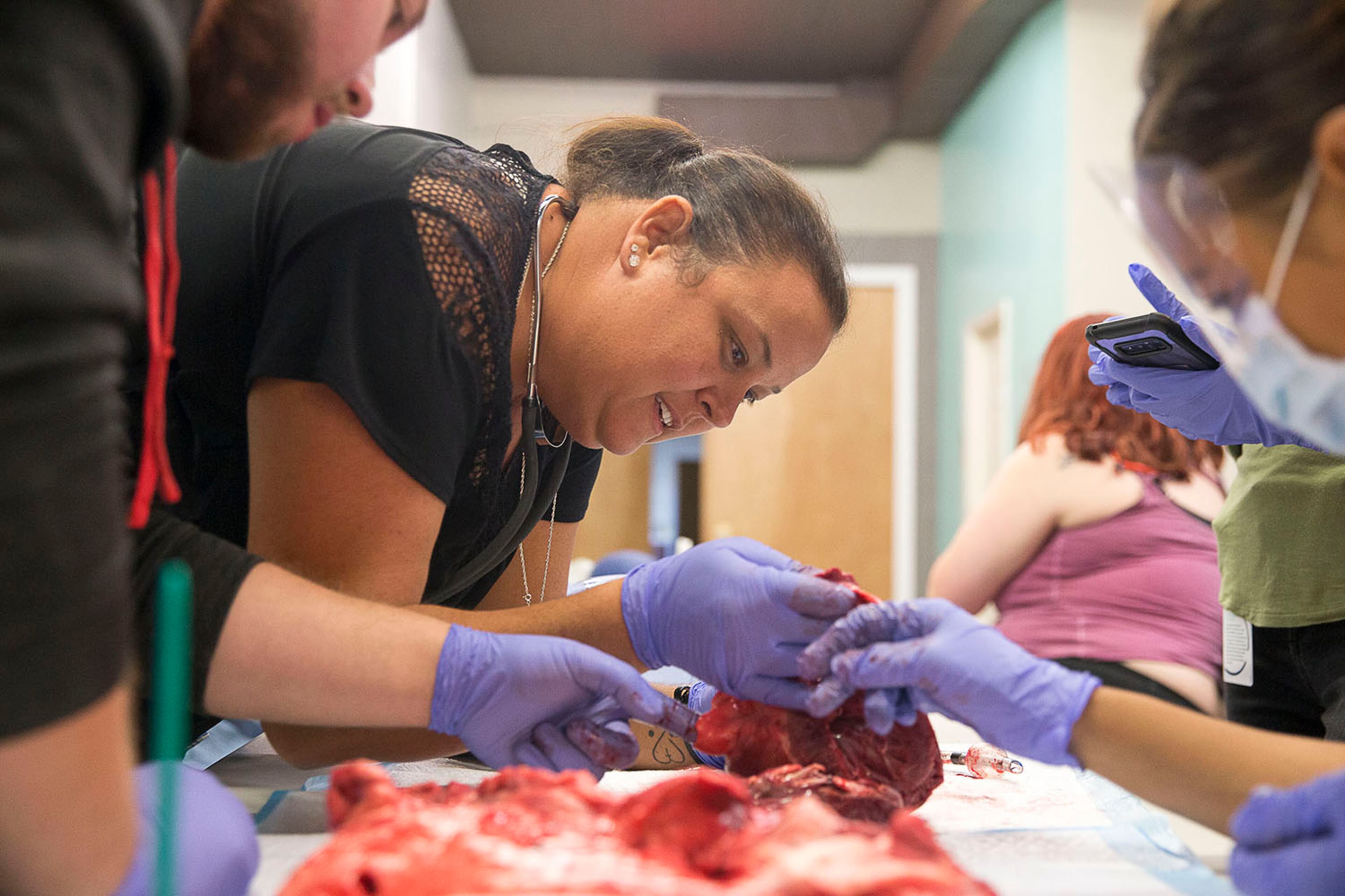 08/13/2019 -- Covington, Georgia -- Emilee Miller of Covington examines the heart of a pig during a hands on lab at the Georgia Institute of EMS in Covington, Tuesday, August 13, 2019. Students directed the heart and lungs of a pig. (Alyssa Pointer/alyssa.pointer@ajc.com)
