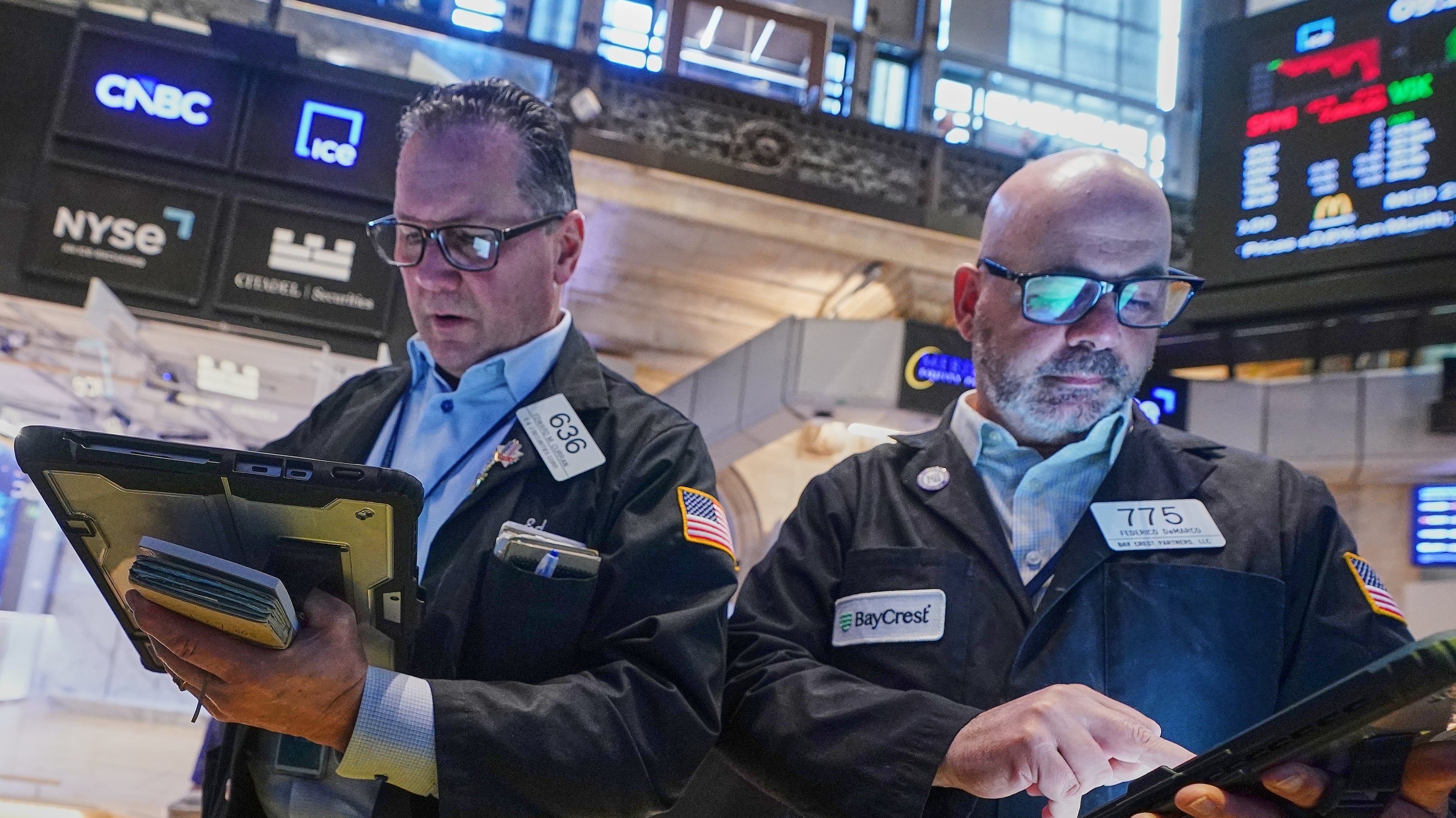Traders Edward Curran, left, and Fred Demarco work on the floor of the New York Stock Exchange, Wednesday, June 3, 2026. (AP Photo/Richard Drew)