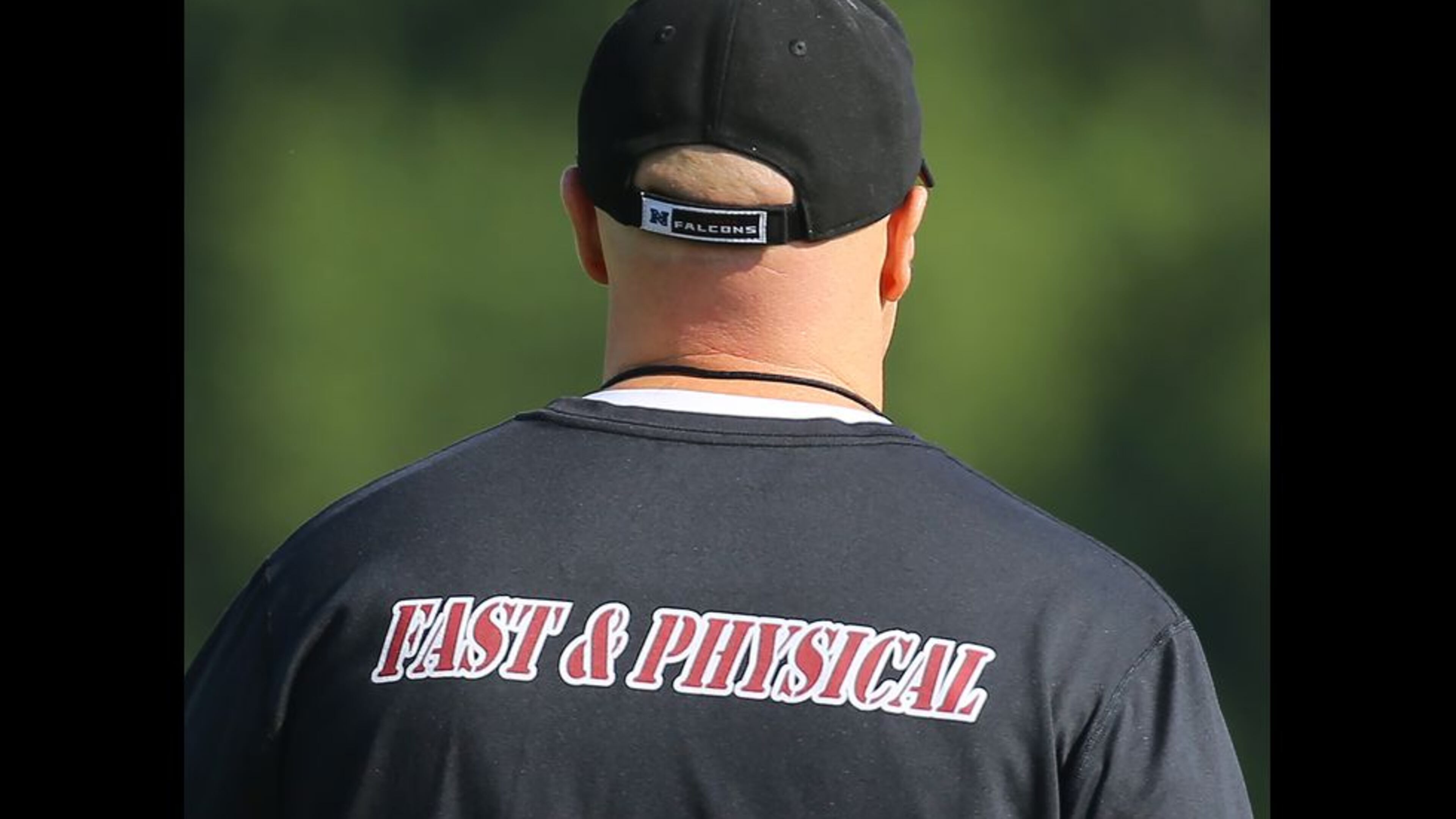 073115 FLOWERY BRANCH: The back of head coach Dan Quinn’s shirt reads “Fast and Physical” as he leads his team through the first day of training camp on Friday, July 31, 2015, in Flowery Branch. Curtis Compton / ccompton@ajc.com