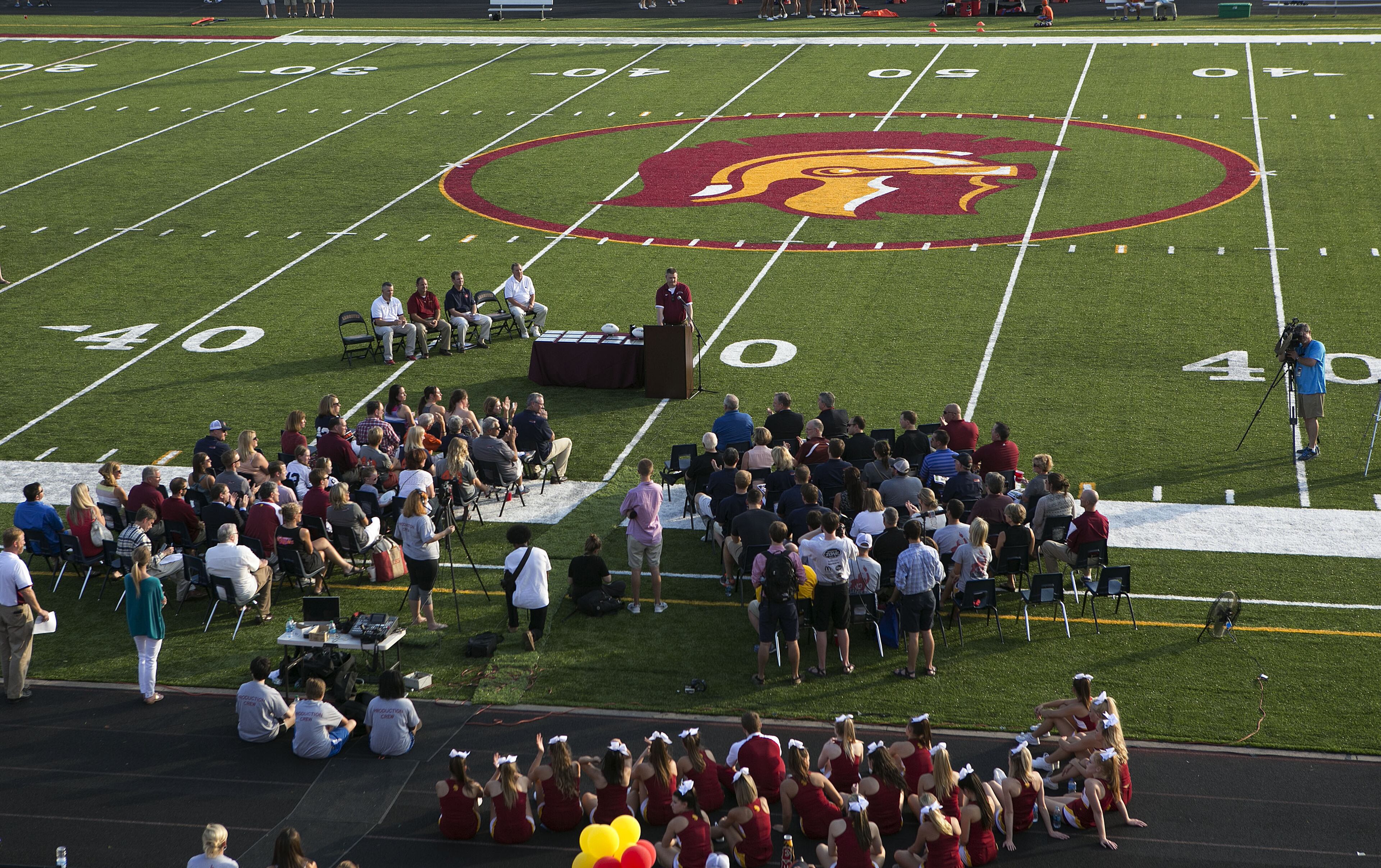 The family of the late fullback Philip Lutzenkirchen witness the dedication of the newly resurfaced and newly named Lutzie Field at Lassiter High in Marietta on Friday August 14th, 2015. (Photo by Phil Skinner)