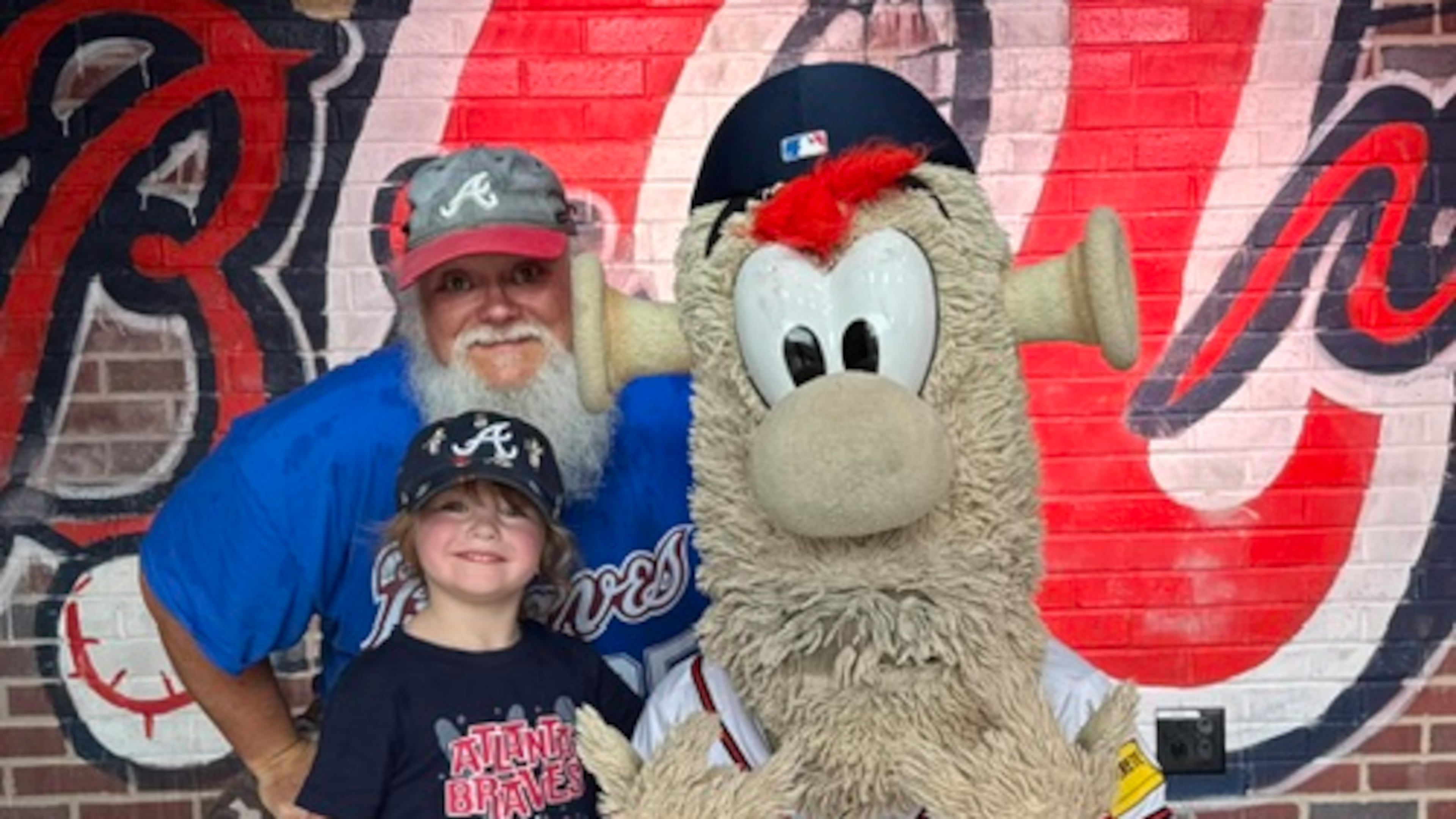 Long-time Braves fan Jimmie Boulware and his granddaughter Oakley hang out with Blooper. (Photo courtesy of Jimmie Boulware)