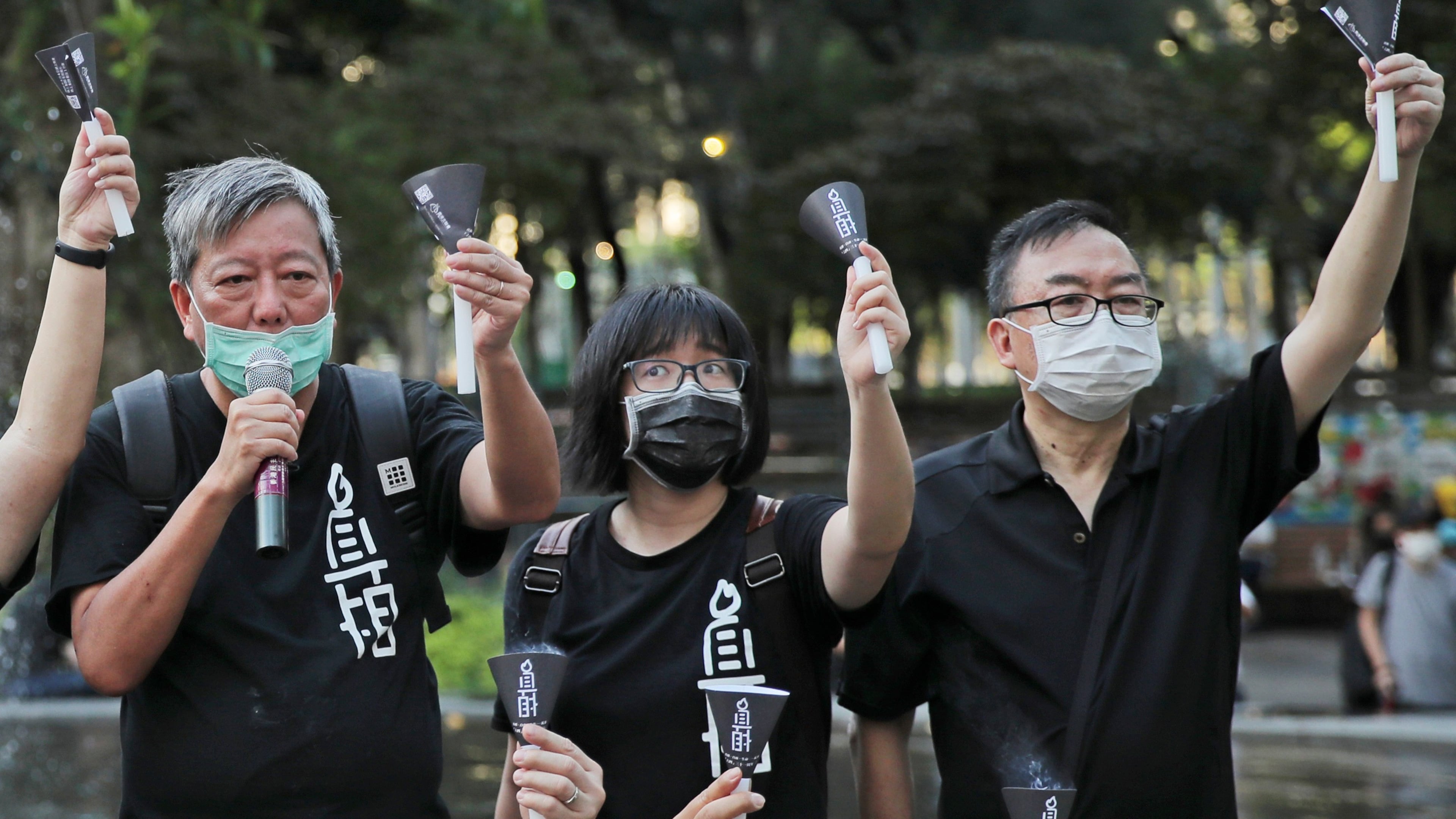 FILE - Fom left, pro-democracy activists Lee Cheuk-yan, Chow Hang-tung, and Cheung Man-kwong attend a gathering to mourn for those killed in the 1989 Tiananmen crackdown at Victoria Park, in Hong Kong on June 4, 2020. (AP Photo/Kin Cheung, File)