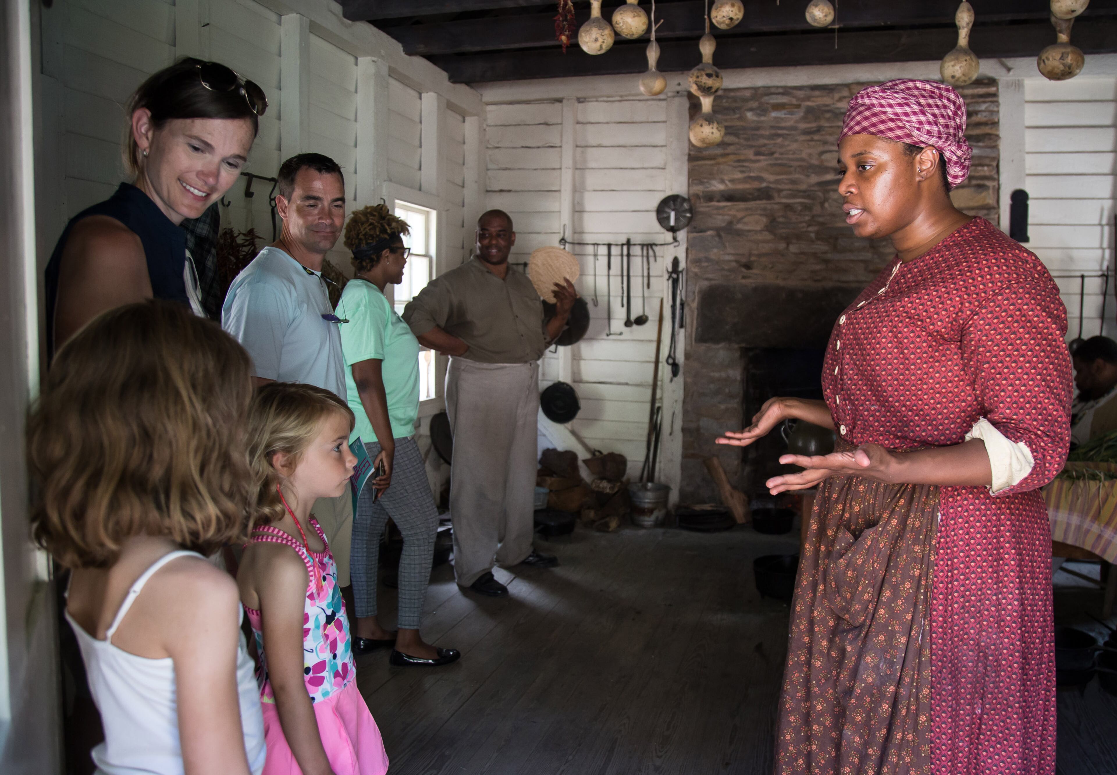 Museum interpreter Alexandria Sweat (R) talks to a small group during one of the theatre performances at the Juneteenth program that focuses on the appreciation and commemoration of the end of slavery in the United States Sunday, June 17, 2018, at the Atlanta History Center. STEVE SCHAEFER / SPECIAL TO THE AJC