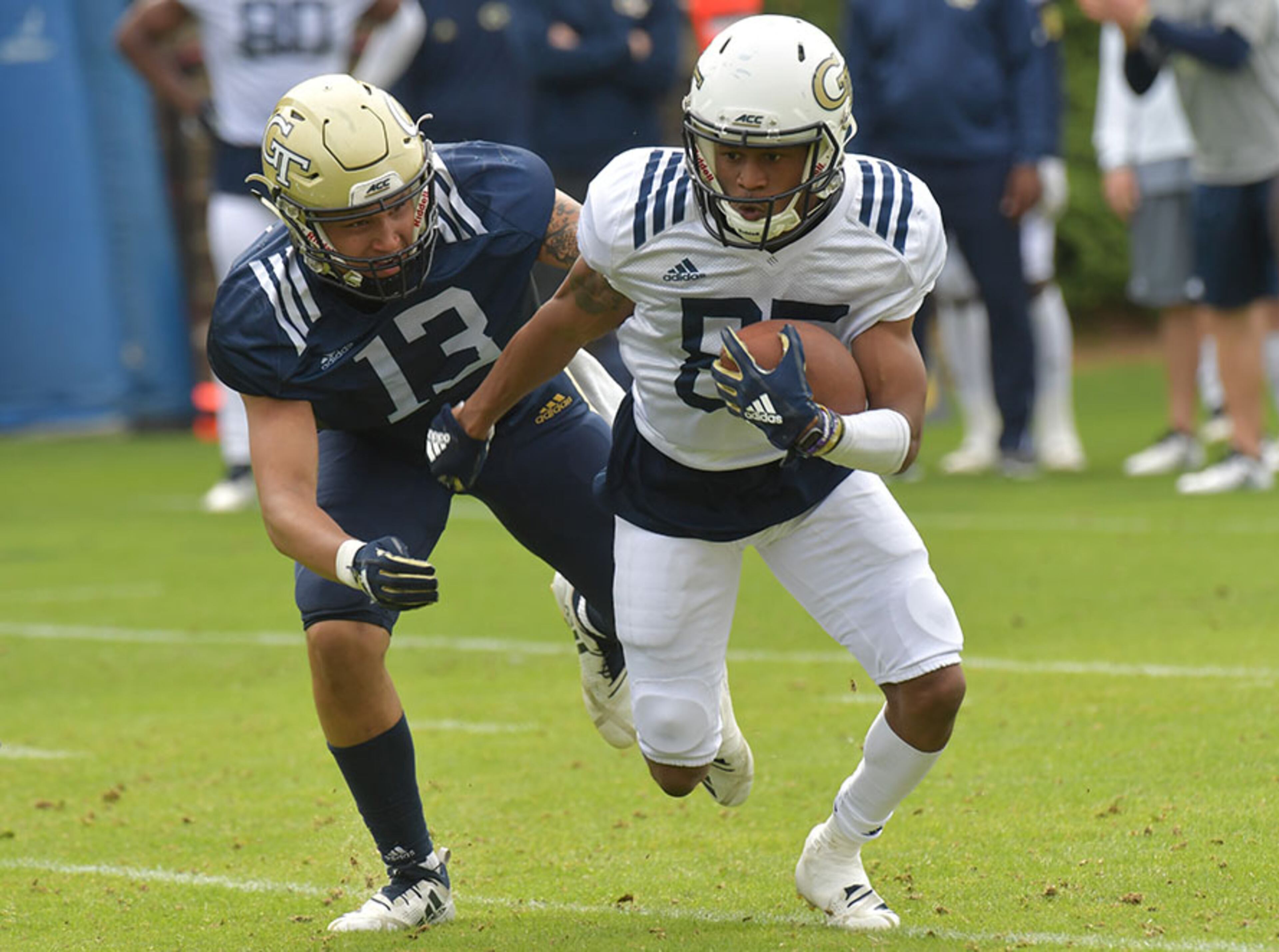 Georgia Tech wide receiver Ahmarean Brown (85) carries the ball away from Georgia Tech defensive back Avery Showell (13) during a practice session Thursday, April 18, 2019, at Georgia Tech's football outdoor practice field in Atlanta.
