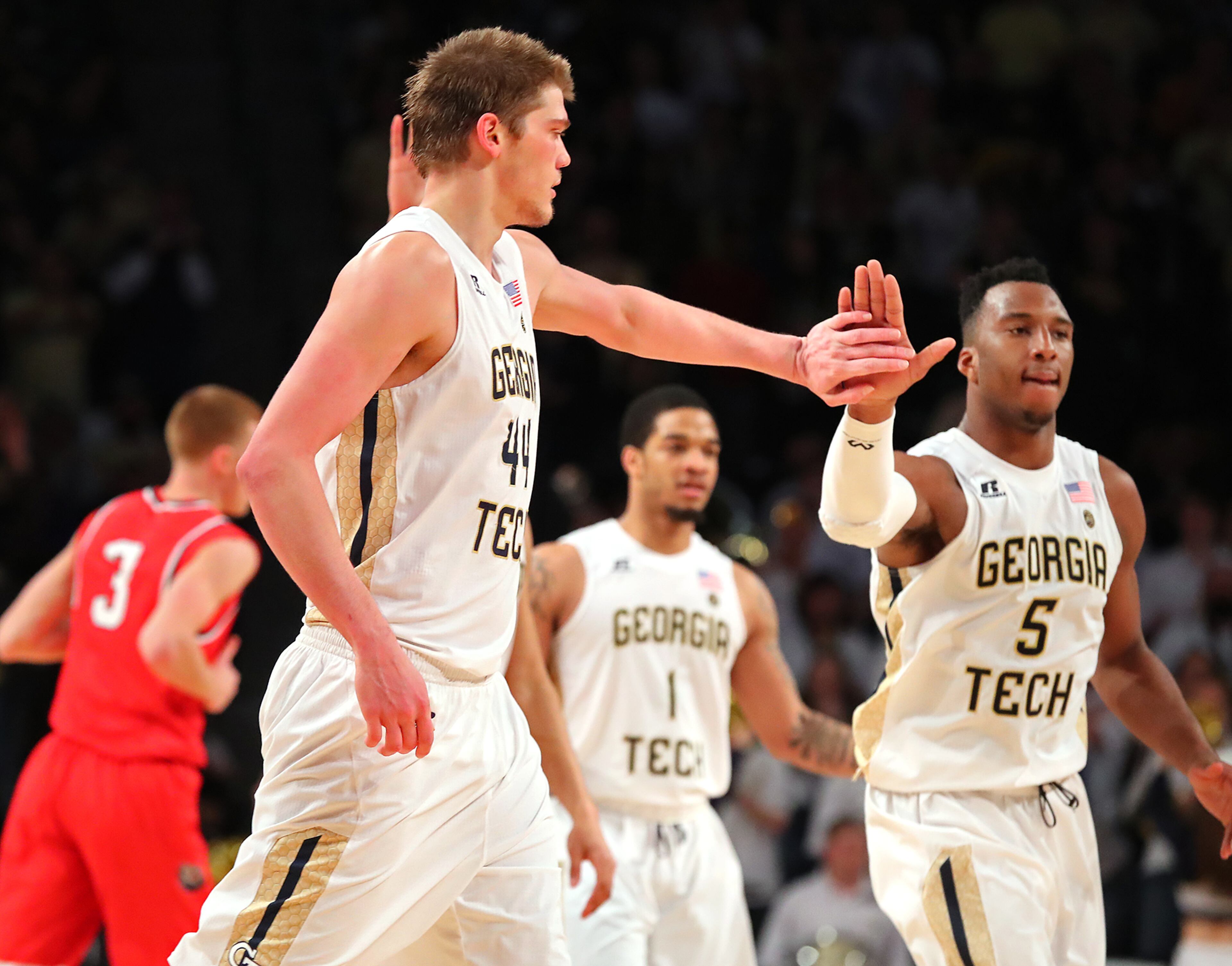 Ben Lammers gets five from Josh Okogie after a basket in
Sunday's game.
