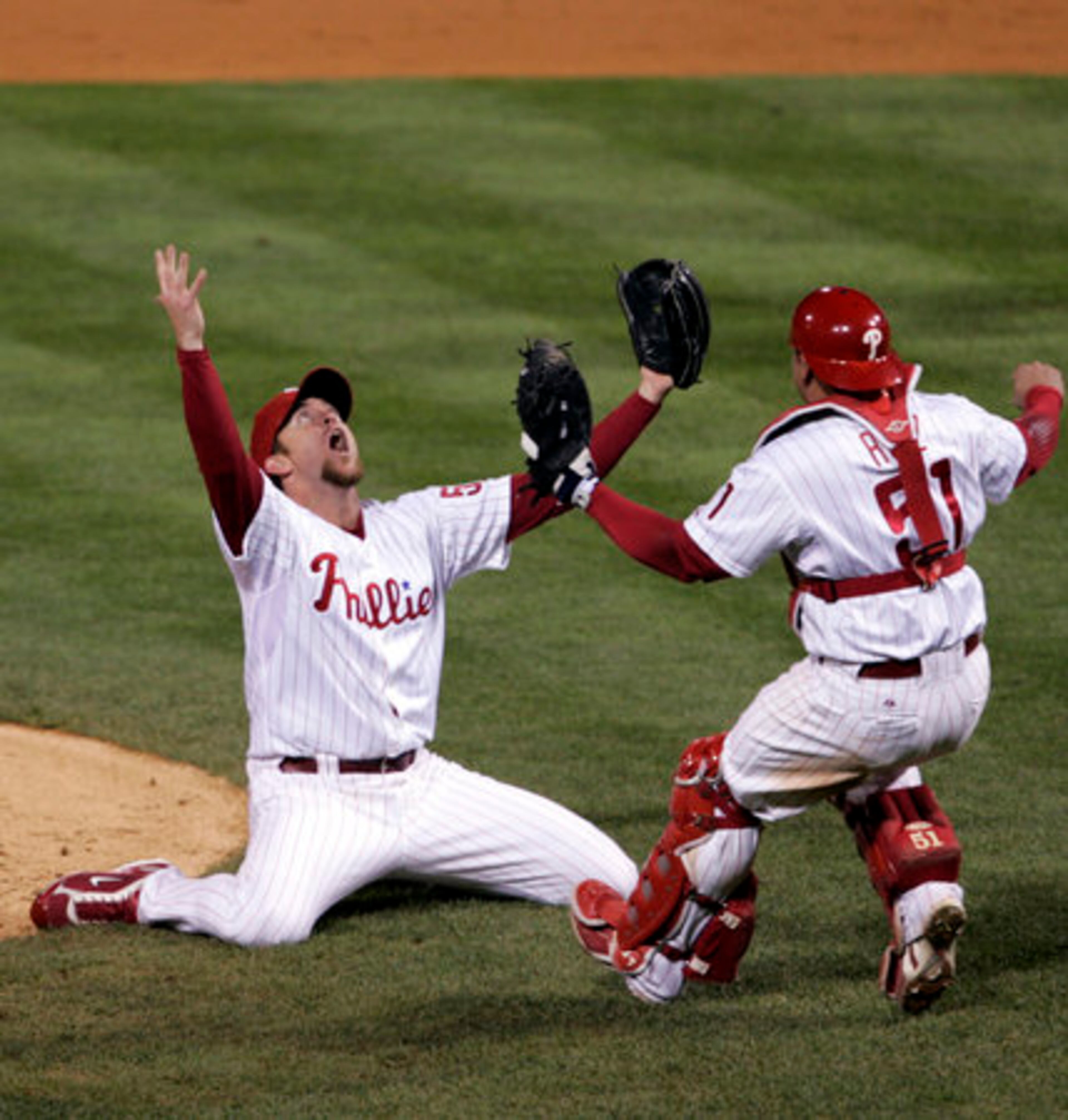 Phillies closer Brad Lidge (left) and catcher Carlos Ruiz come together on the mound.