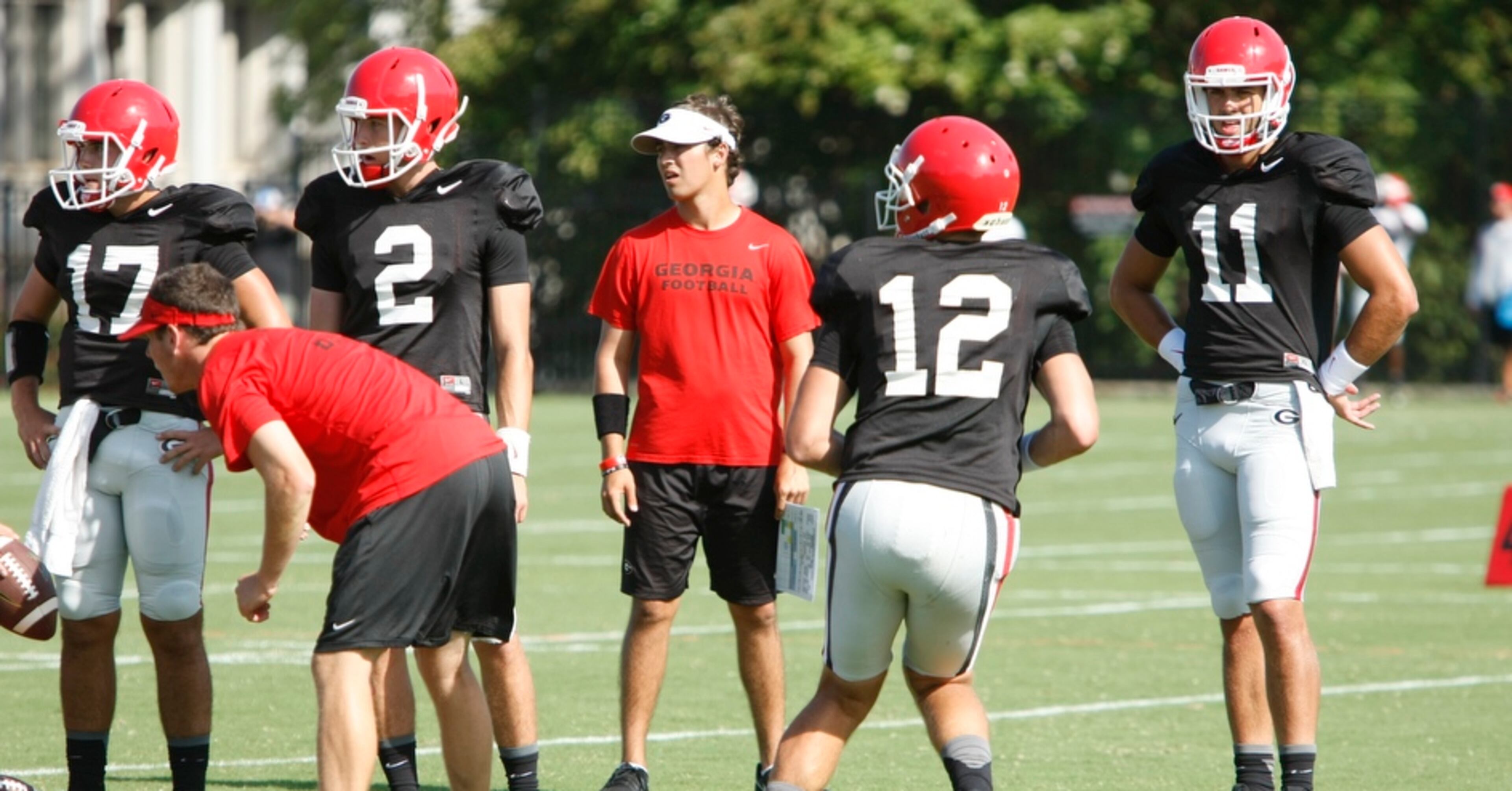 UGA quarterback Greyson Lambert (11) looks on as UGA quarterback Brice Ramsey (12) runs a passing drill during Tuesday's practice. Lambert and Ramsey have been rotating with Faton Bauta as first team quarterback over the summer.