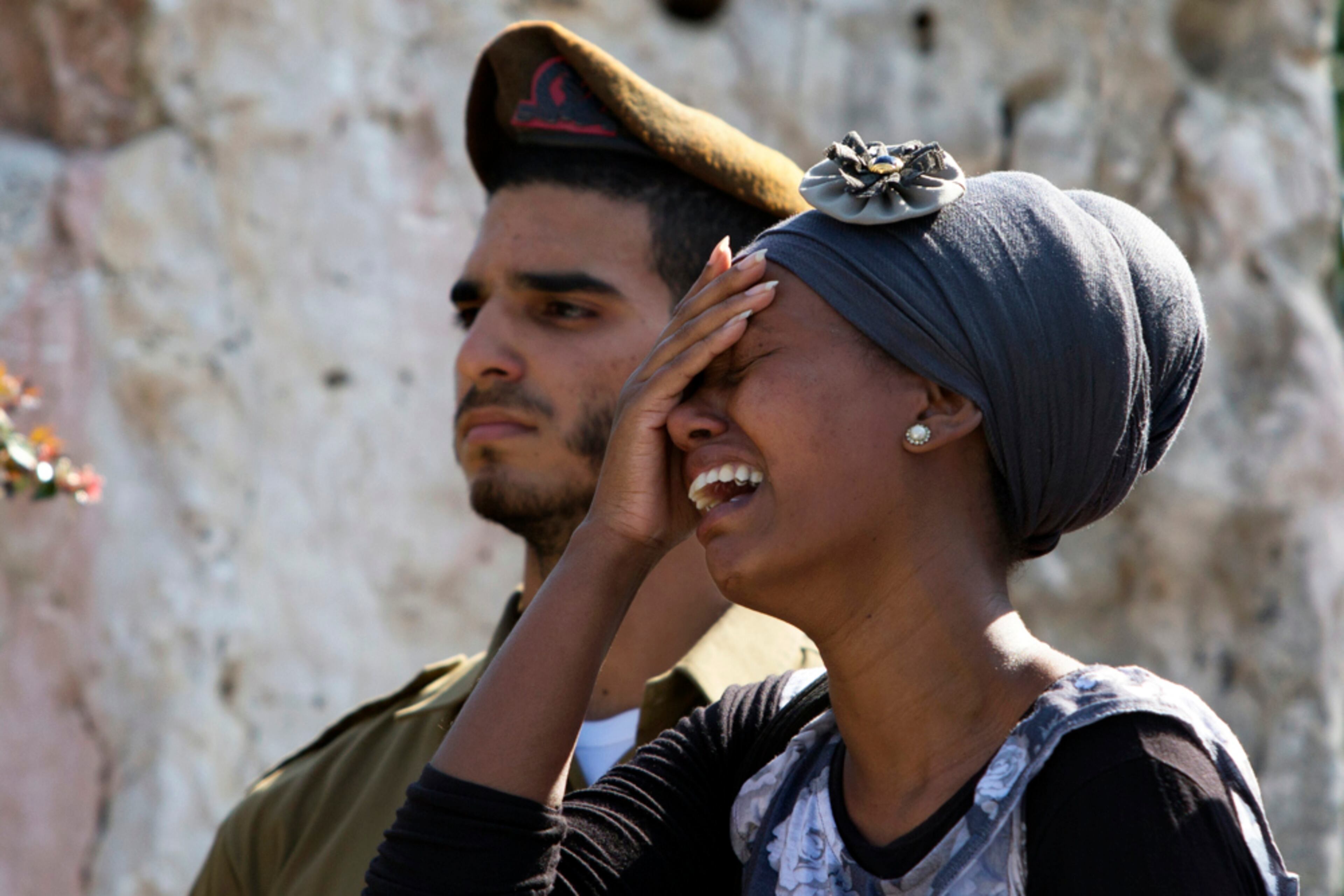 MOURNING THE DEAD--An Israeli woman cries during the funeral of Staff Sgt. Moshe Melako, 20, at the Mount Herzel military cemetery in Jerusalem, Monday, July 21, 2014. Melako was one of 13 soldiers killed in several separate incidents in Shijaiyah on Sunday, as Israel-Hamas fighting exacted a steep price, killing scores of Palestinians and more than a dozen Israeli soldiers and forcing thousands of terrified Palestinian civilians to flee their devastated Shijaiyah neighborhood, which Israel says is a major source for rocket fire against its civilians. (AP Photo/Sebastian Scheiner)