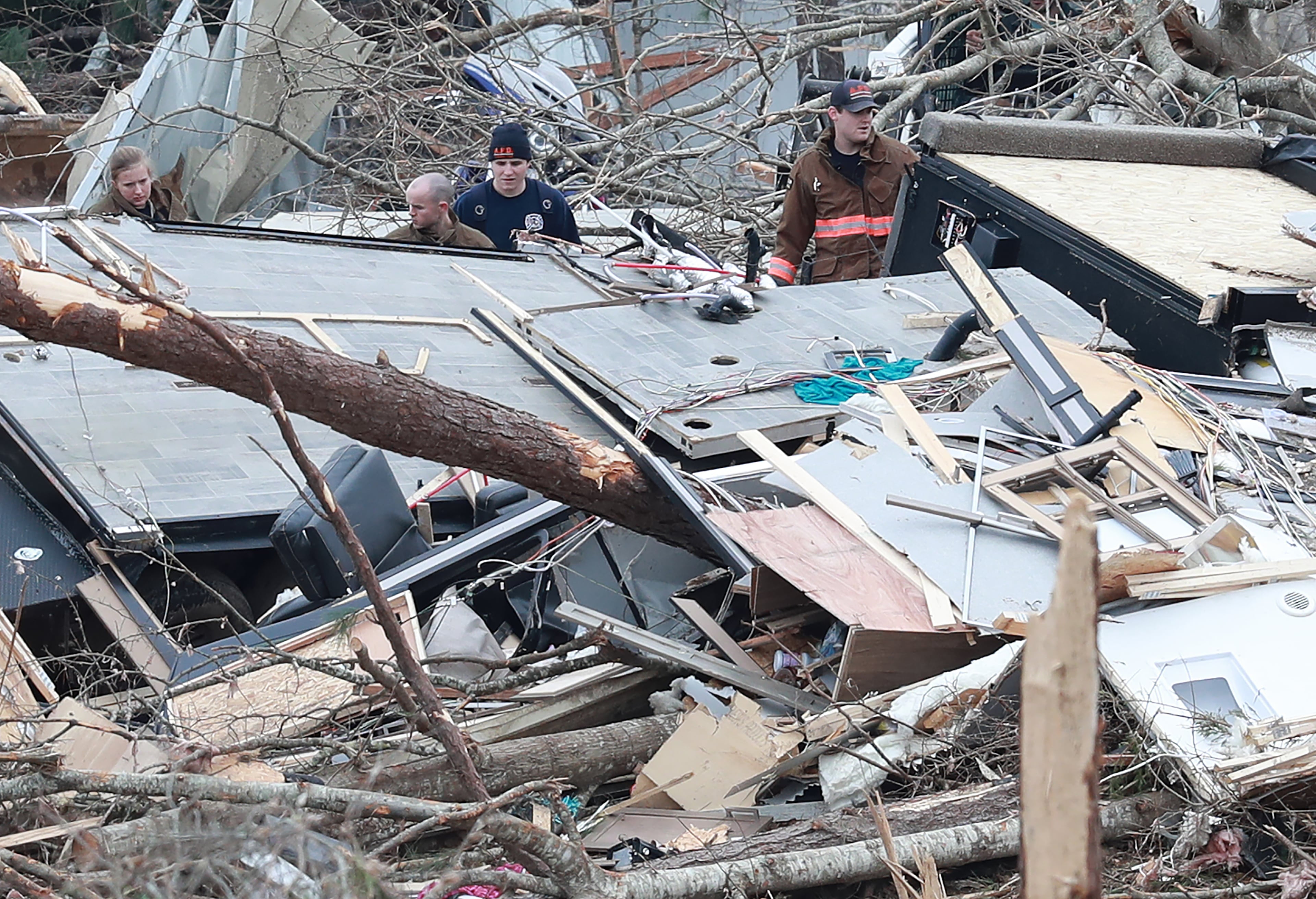 Rescue workers, local residents, and volunteers search the remains of a home along Lee Road 38 after a F-3 tornado on Monday, March 4, 2019, in Beauregard. Twenty-three people -- including a six-year-old -- were killed by a storm Sunday, though that number is expected to climb, Lee County Sheriff Jay Jones told reporters Monday morning. The destruction area is at least a half a mile wide and at least a mile long, he added. Curtis Compton/ccompton@ajc.com