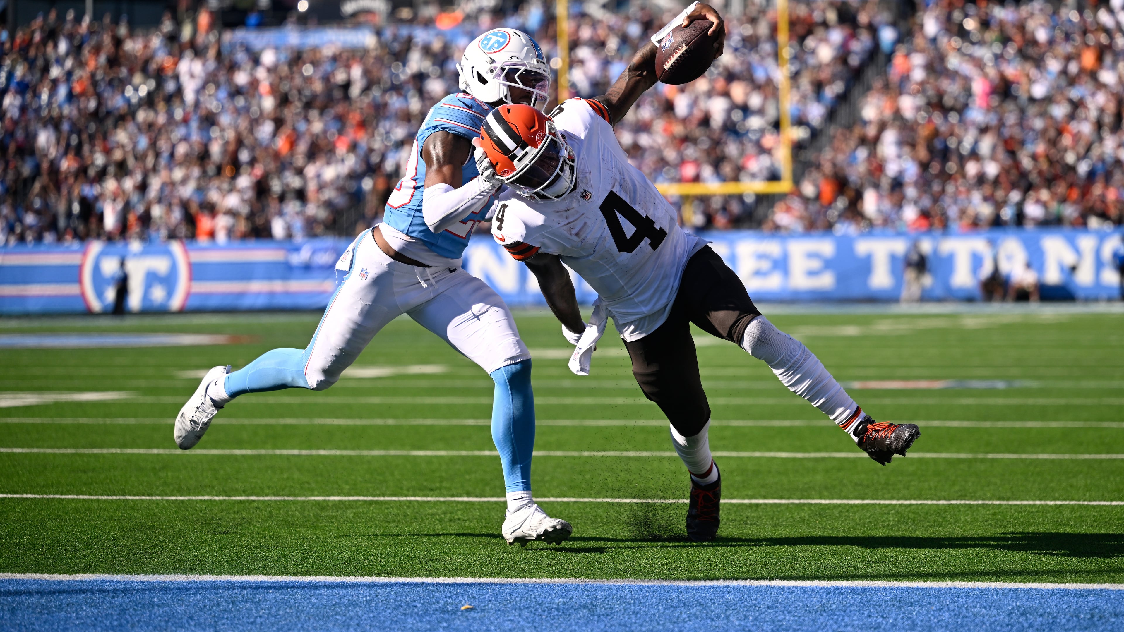 Cleveland Browns quarterback Deshaun Watson (4) scores a touchdown past Tennessee Titans safety Kevin Winston Jr. (23) during the second half of an NFL football game in Nashville, Tenn., Sunday, Oct. 25, 2026. (AP Photo/John Amis)