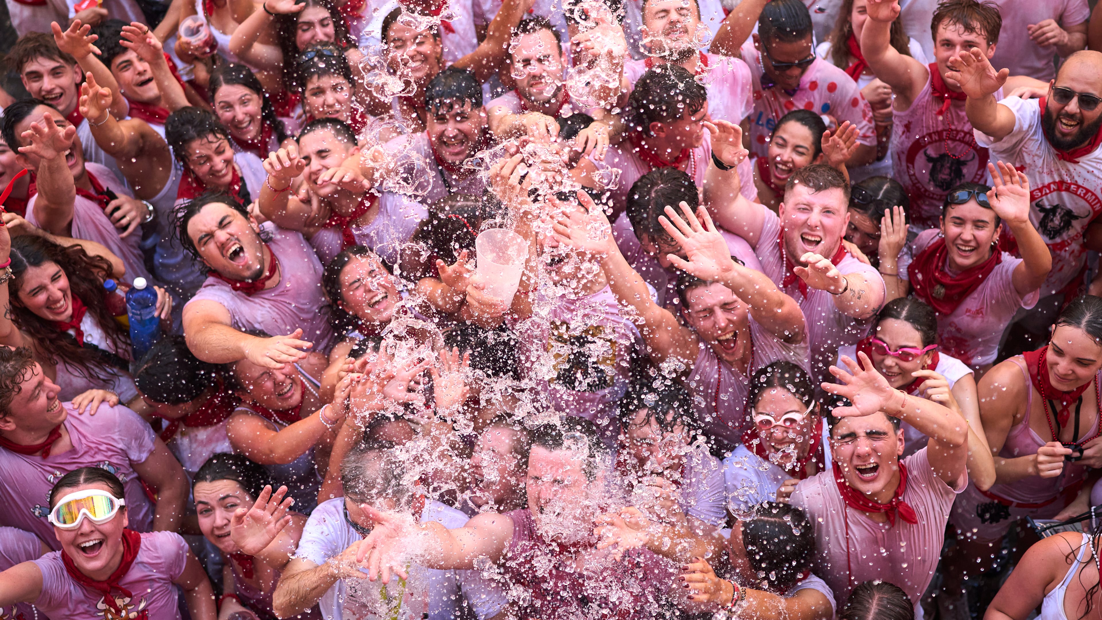 Revelers celebrate as the txupinazo, the traditional rocket marking the start of the San Fermín festival, kicks off nine days of uninterrupted festivities in Pamplona, Spain, Monday, July 6, 2026. (AP Photo/Miguel Oses)