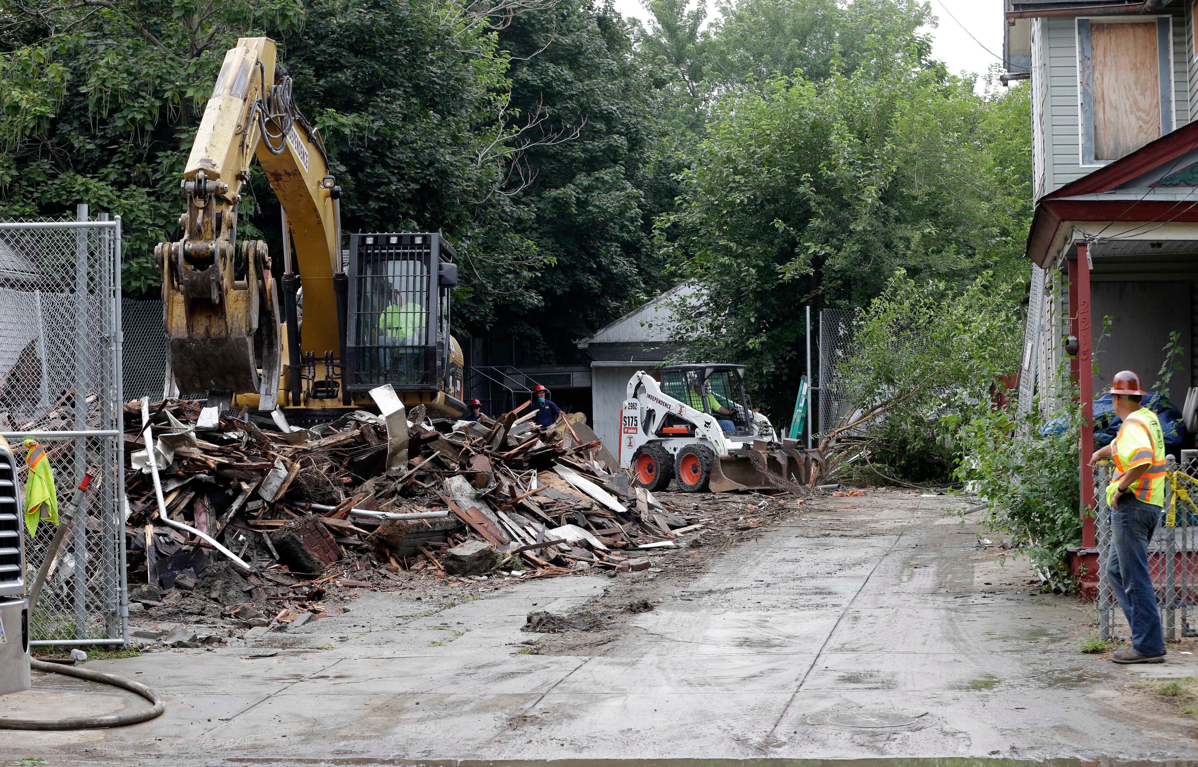 Workers demolish the house where three women were held captive and raped for more than a decade, Wednesday, Aug. 7, 2013, in Cleveland. Authorities want to make sure the rubble isn't sold online as "murderabilia," though no one died there. The house was torn down as part of a deal that spared Ariel Castro a possible death sentence. He was sentenced last week to life in prison plus 1,000 years. Castro apologized but blamed his addiction to pornography. (AP Photo/Tony Dejak)