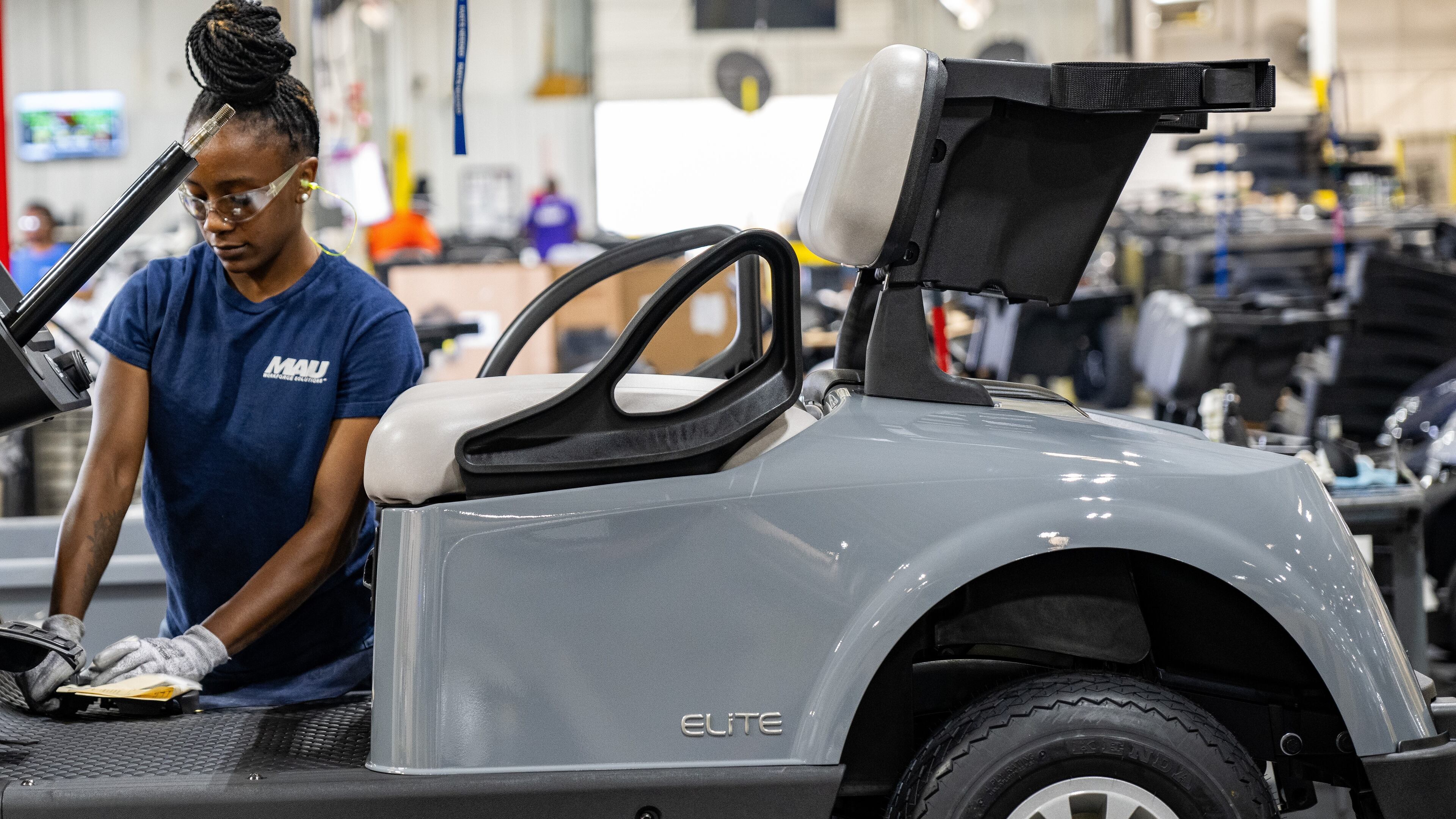 Worker at Textron Specialized Vehicles making a golf cart on assembly line in Augusta.