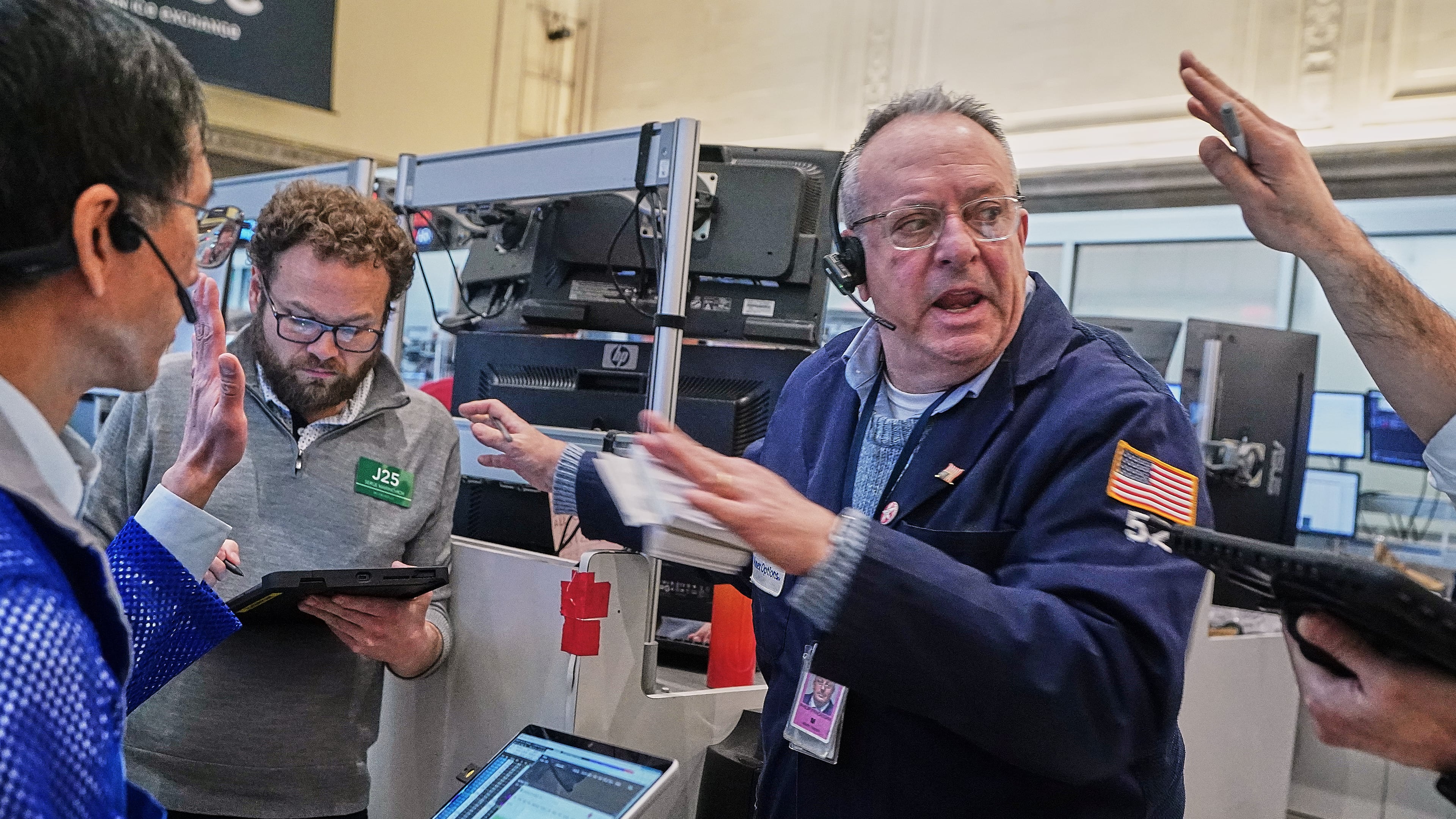 Phil Fracassini, center, works with fellow options traders on the floor of the New York Stock Exchange, Tuesday, Feb. 3, 2026. (AP Photo/Richard Drew)