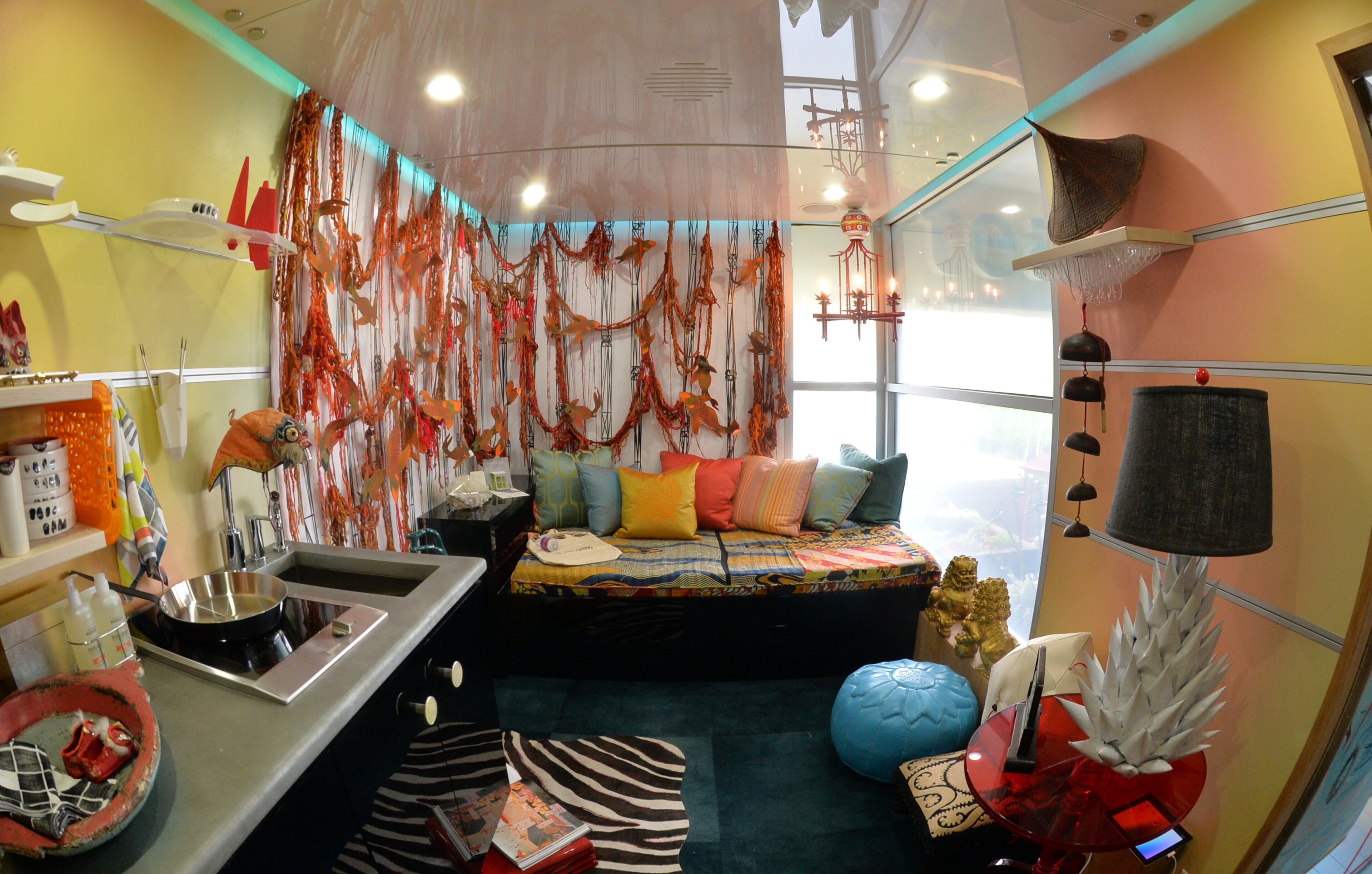 Interior of SCADpad Asia, one of three fully functional and fully furnished 135-square-foot SCADpad units, on the 4th floor of SCAD Atlanta's parking garage on Tuesday, April 15, 2014. Inside SCADpad Asia, a geometic wallpaper adorns the walls, which was painted by BFA and MFA painting graduate Liz Winnel. The wallpaper overlays a soundboard designed by SCAD student Ross Fish. When you touch the wall, an algorithm is triggered to produce randomized audio file sounds. Savannah College of Art and Design (SCAD) unveiled SCADpad, a unique micro-housing and adaptive reuse experiment that transformed the parking structure of its midtown Atlanta location into a sustainable community that proposes an answer to the world's growing urban housing challenges. HYOSUB SHIN / HSHIN@AJC.COM