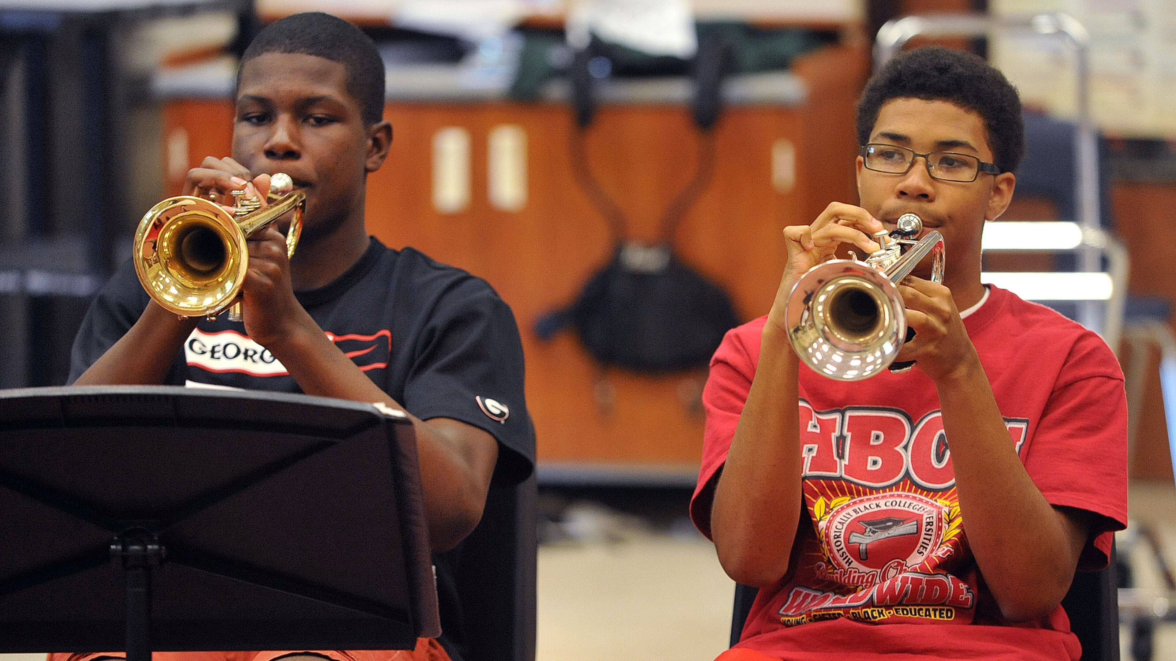 Tri-Cities High School students Christopher Kelly (left), and Marc Fleming play trumpet during a Jazz Ensemble rehearsal in May. The school’s visual and performing arts magnet program was launched in 1990. KENT D. JOHNSON /KDJOHNSON@AJC.COM