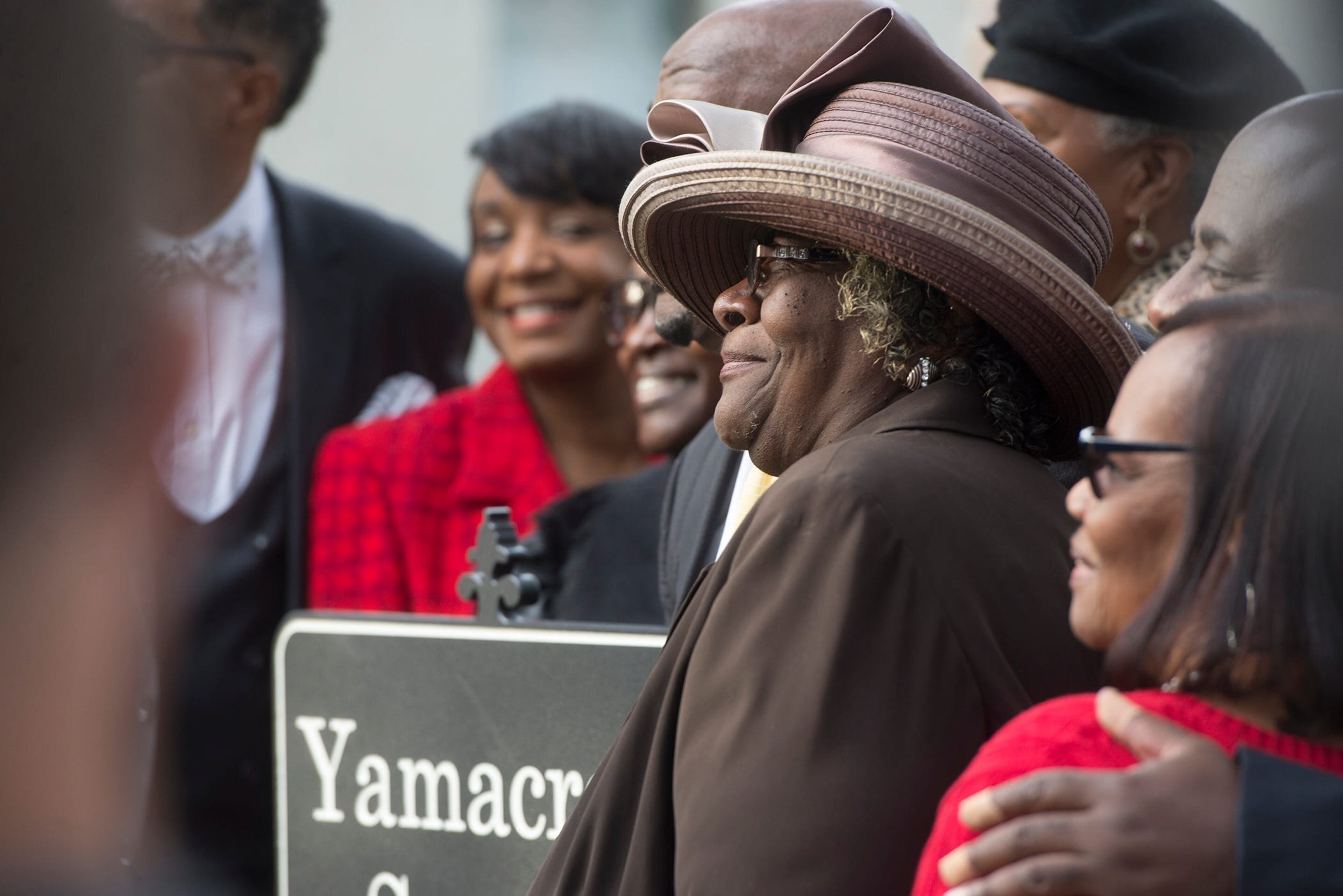 Georgia Benton, the Yamacraw Square ward captain and Yamacraw historian for the National Trust for Historic Preservation, smiles with city leaders as the sign for Yamacraw Square was unveiled on Sunday.