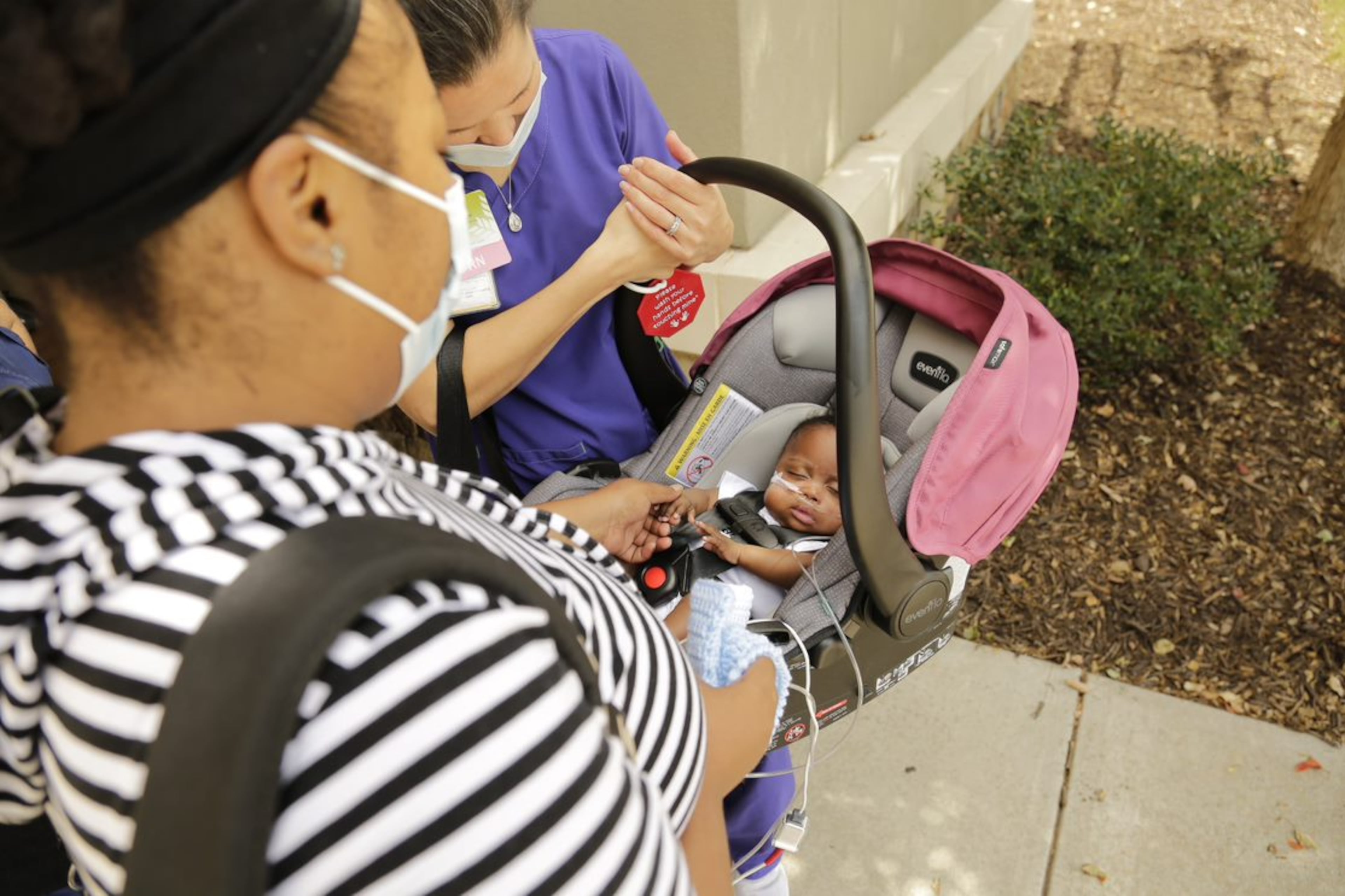 Nurse Sarah Taylor, a NICU nurse, carries baby Jayla in her car seat as she finally goes home after 183 days in the NICU. Taylor grew close to Jayla and her parents. By the end of Jayla's stay at the hospital, Audreona Scott said she started calling Taylor, "Auntie Sarah." They continue to stay in touch and Taylor checks in on Jayla every week since she's gone home. "I definitely consider it a blessing and honor," said Taylor about caring for Jayla. (Contributed)